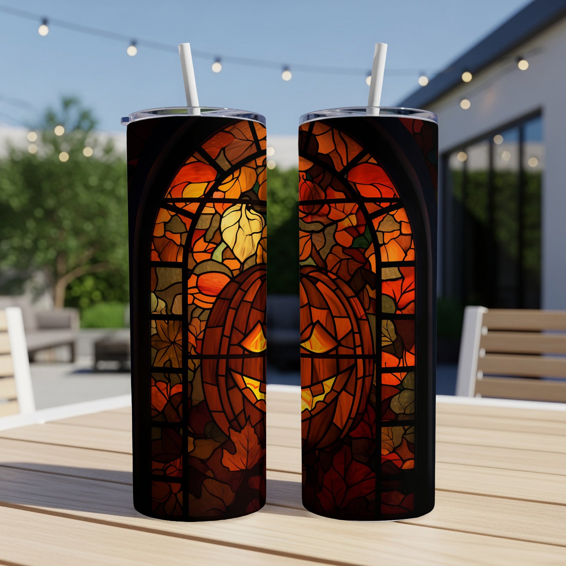 Two tumblers with a stained glass pumpkin and fall leaves design.