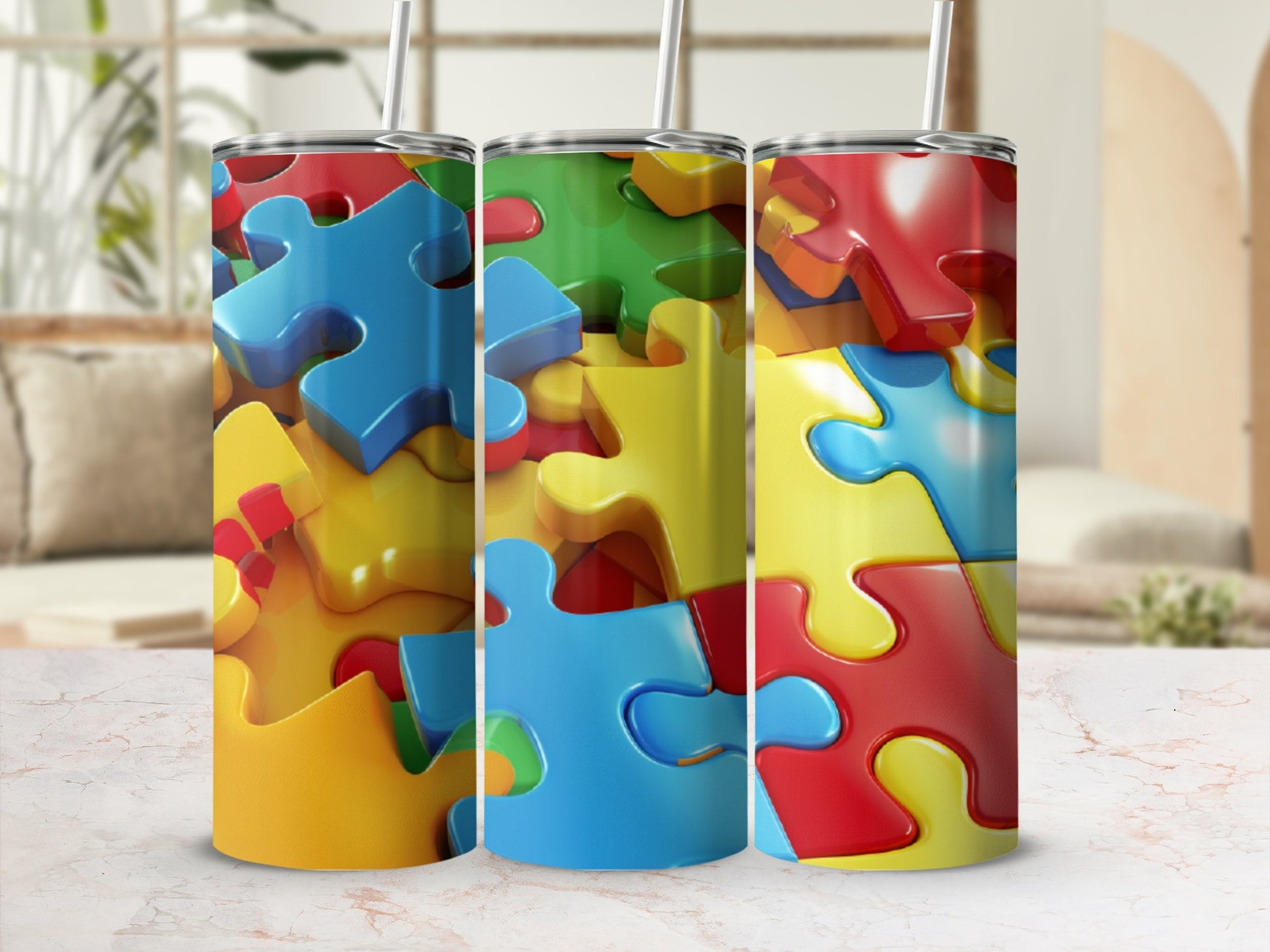 Three stainless steel tumblers with a vibrant, interlocking puzzle piece design.