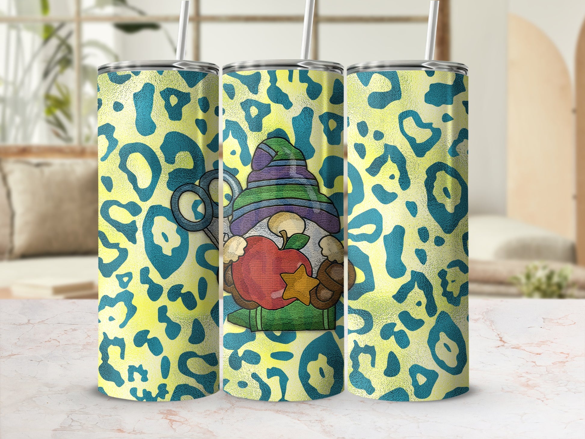 Three tumblers with leopard print and gnome, apple, and scissors design.