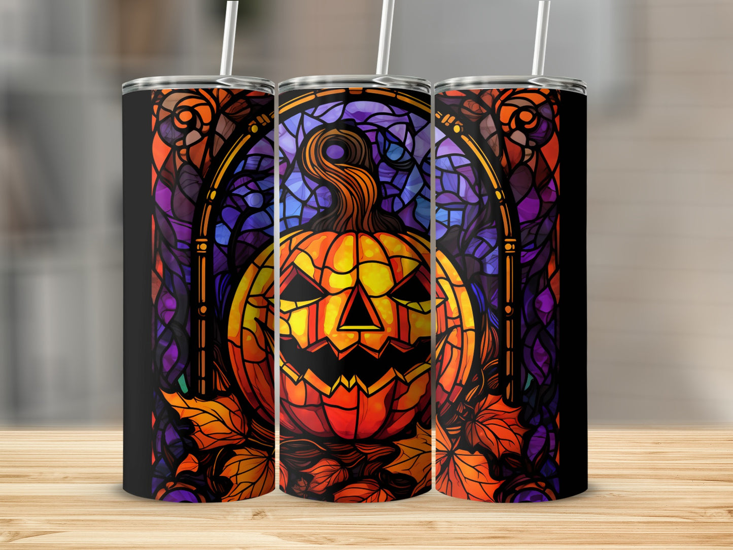 Stained glass pumpkin and autumn leaves pattern on three tumblers.