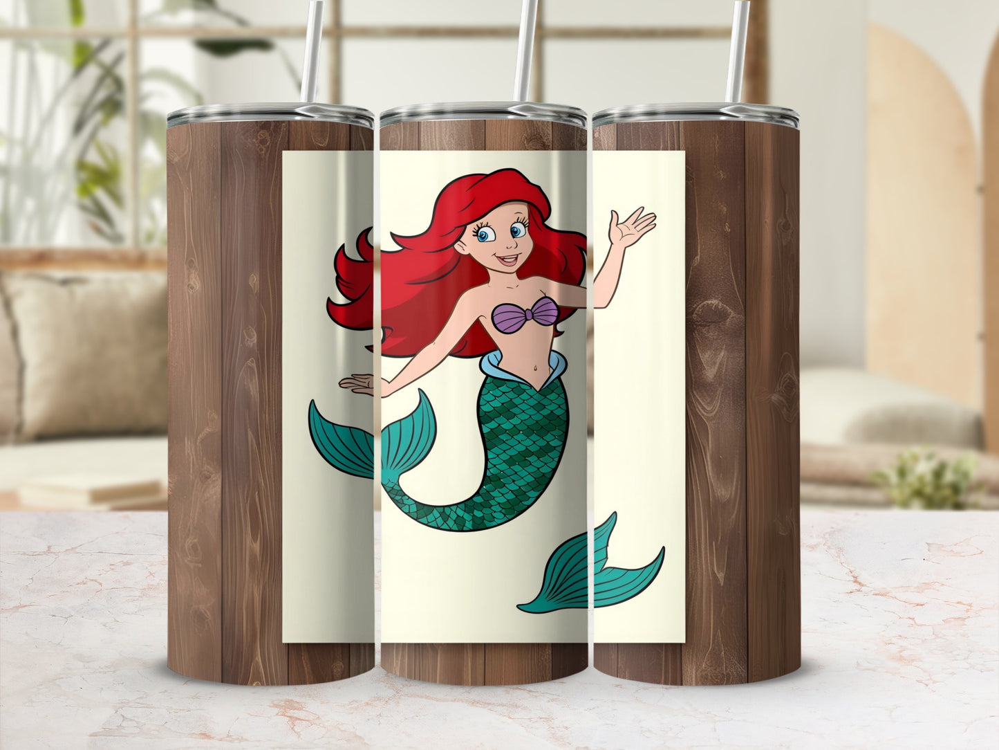 Ariel the mermaid with red hair and green tail waves on a tumbler.