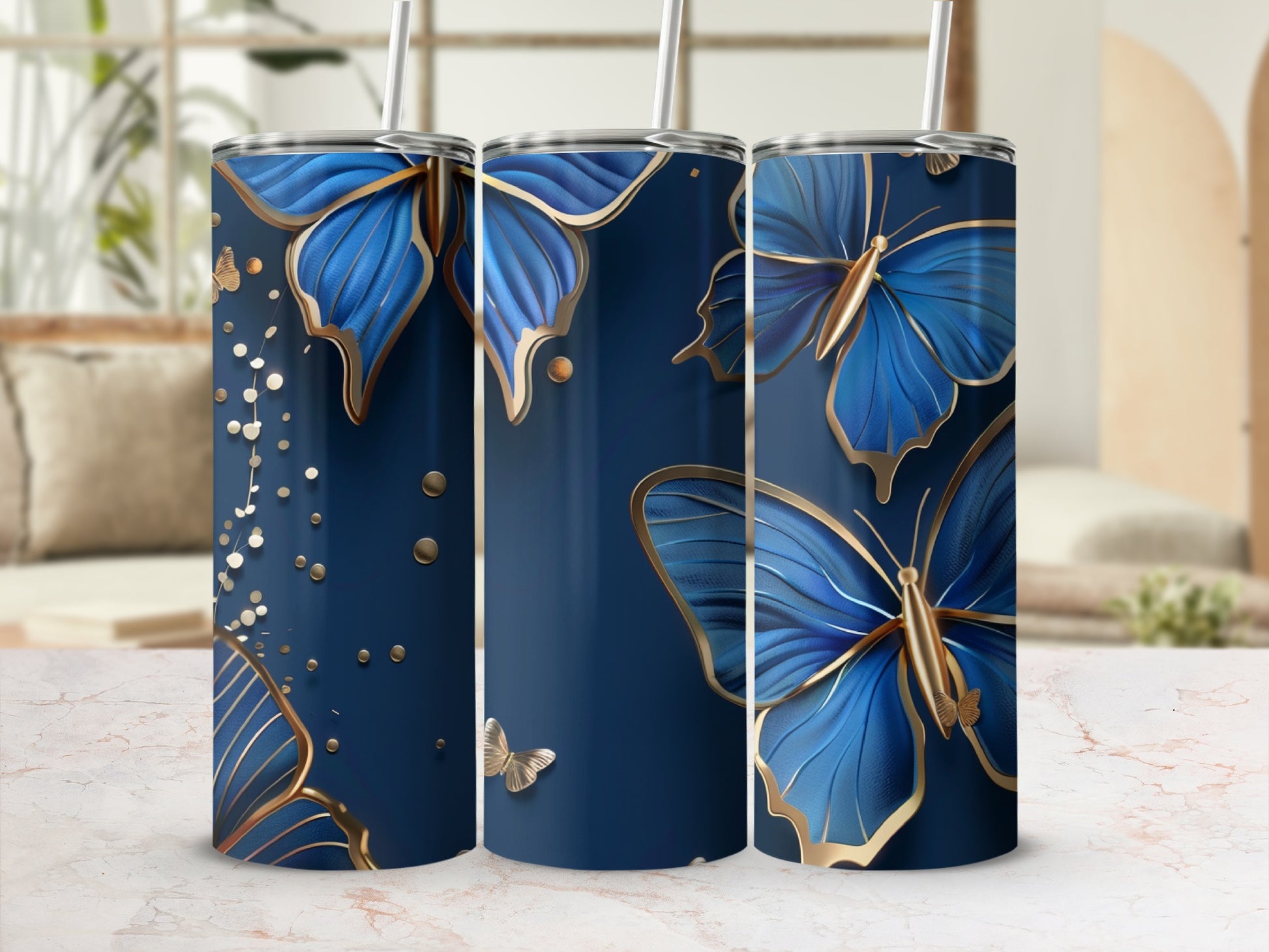 Three navy tumblers with gold butterfly and glitter designs.