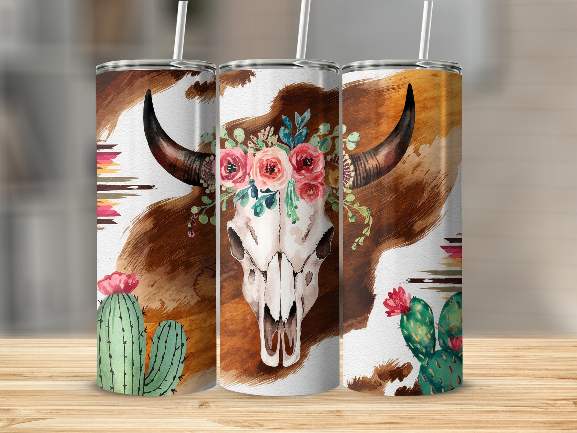 Cow skull with floral crown, cacti, and tribal patterns on a tumbler.