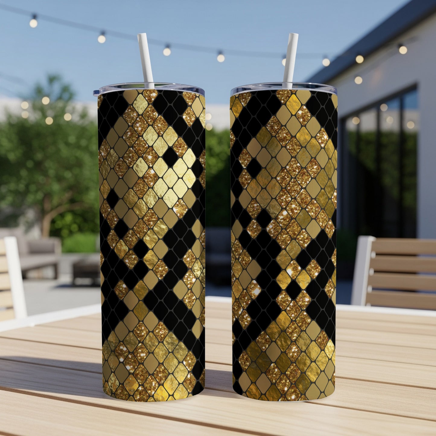Two tumblers with a black and gold diamond pattern and white straws.