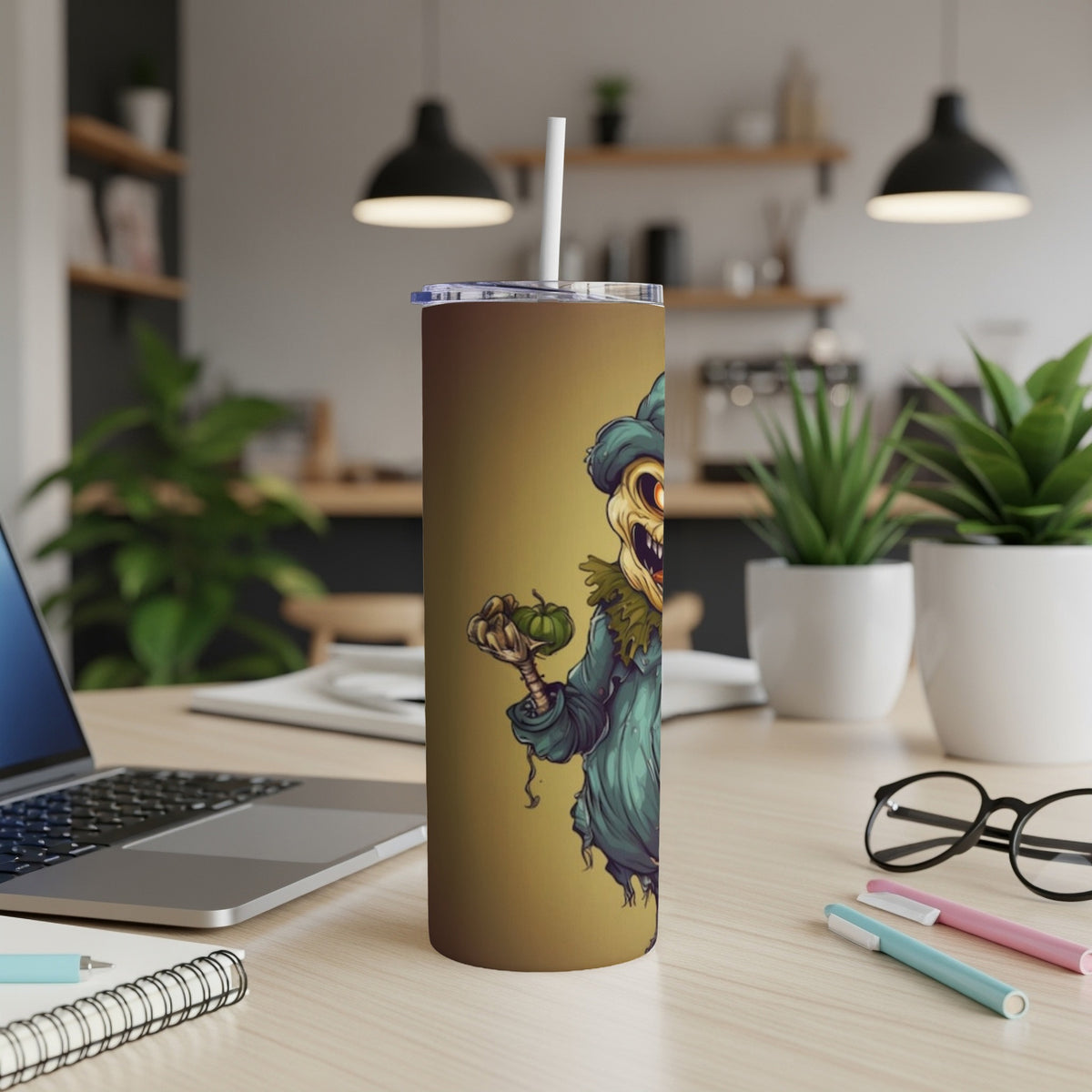 Tumbler with illustration of a grinning scarecrow holding a small pumpkin.