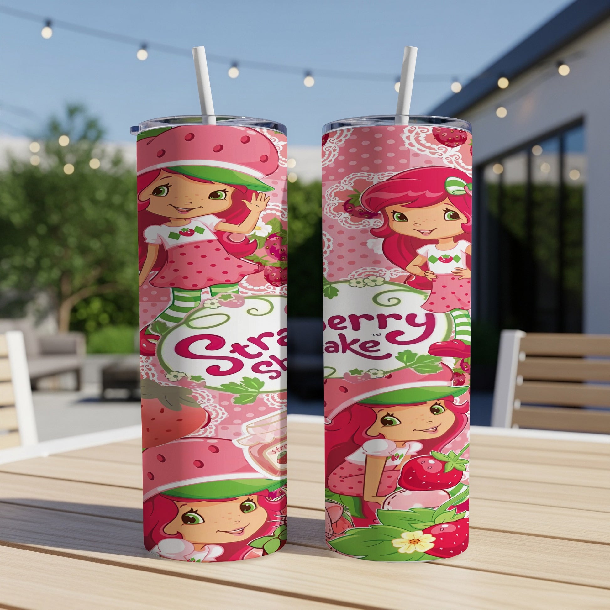 Strawberry Shortcake tumbler with pink and green floral pattern.