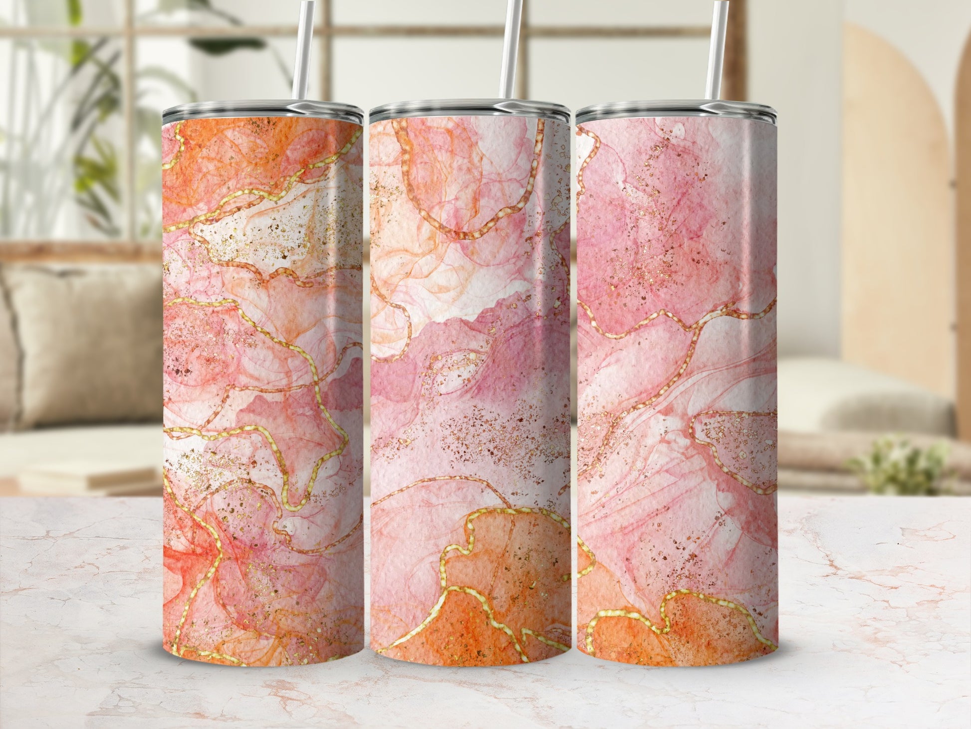 Three tall tumblers with a pink, orange, and gold marble design.