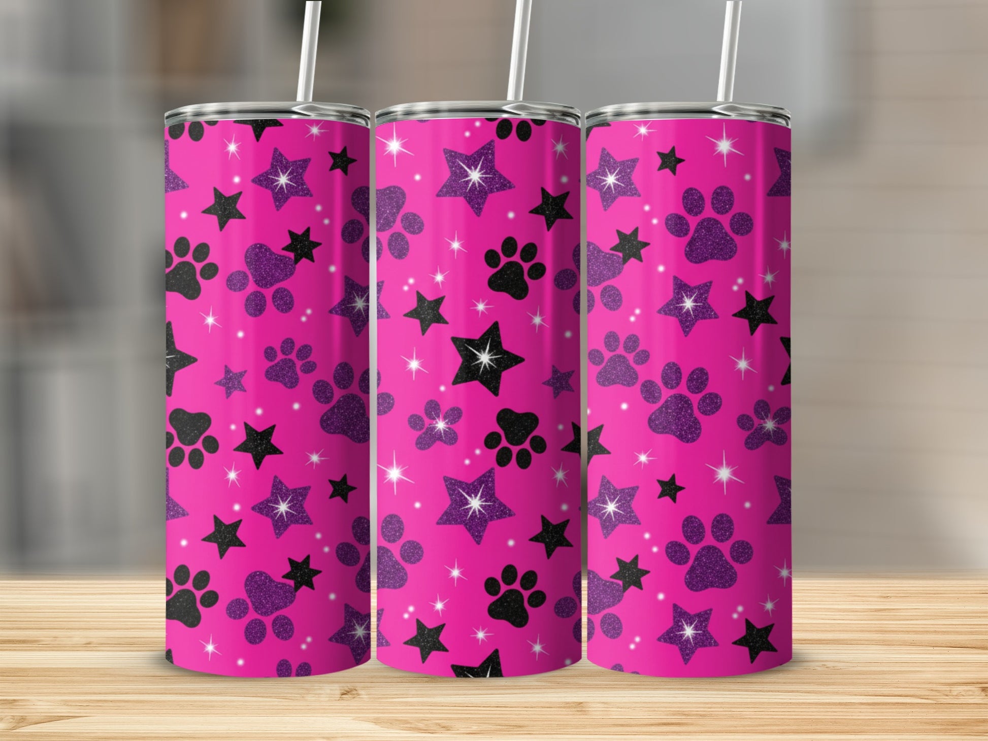 Pink tumbler with black paw prints and sparkly stars.