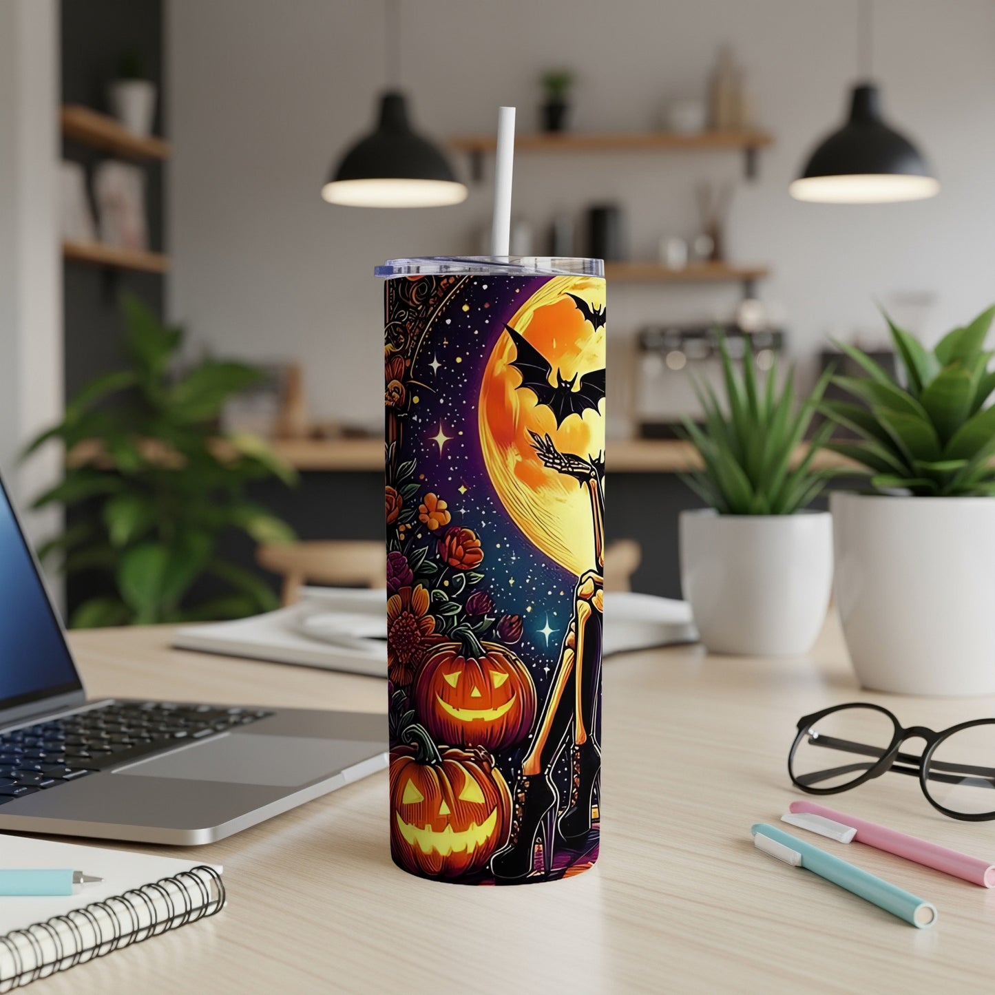 Halloween tumbler with pumpkins, bats, skeleton, and a large moon.