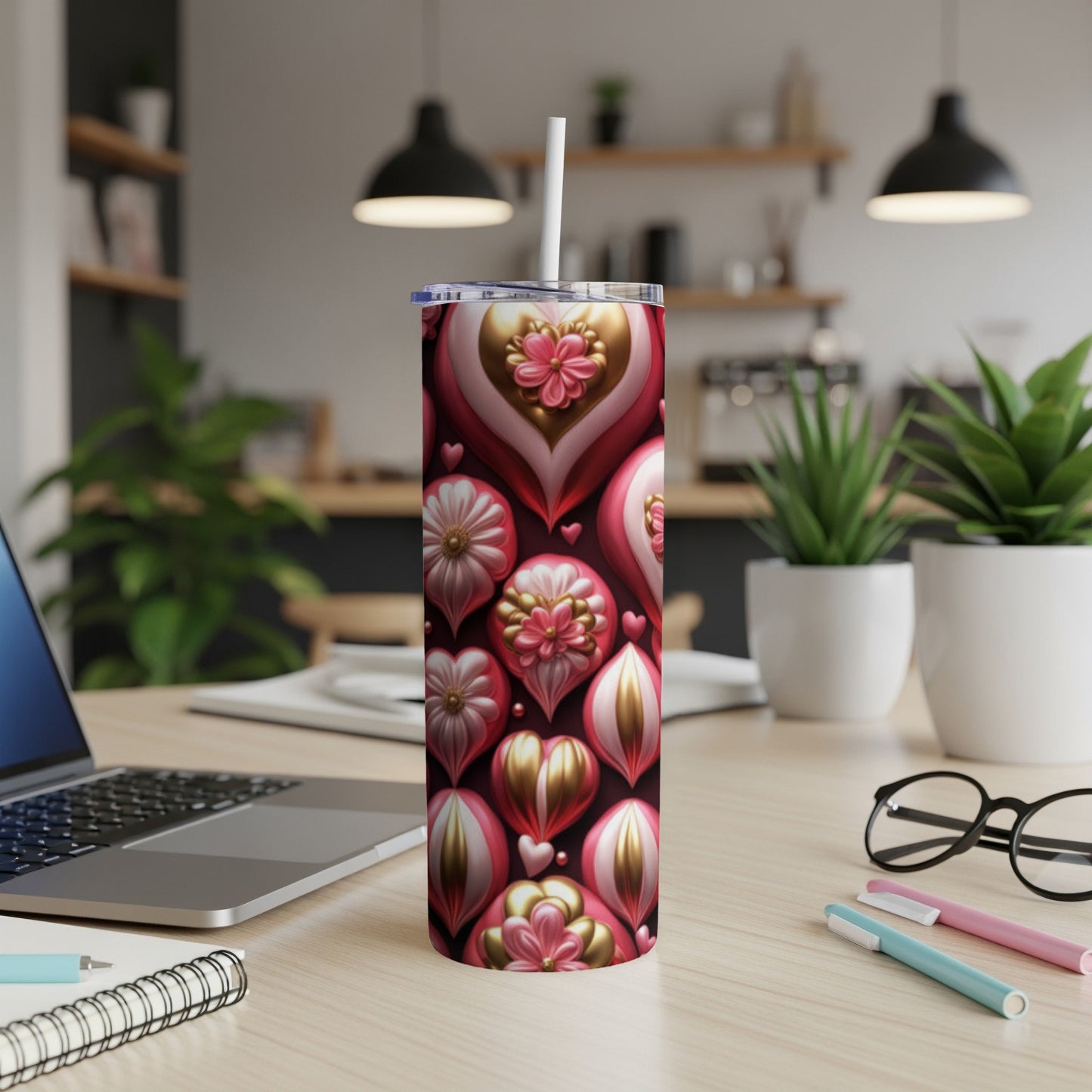 Pink and gold heart-shaped ornaments adorn a tall tumbler with a straw.