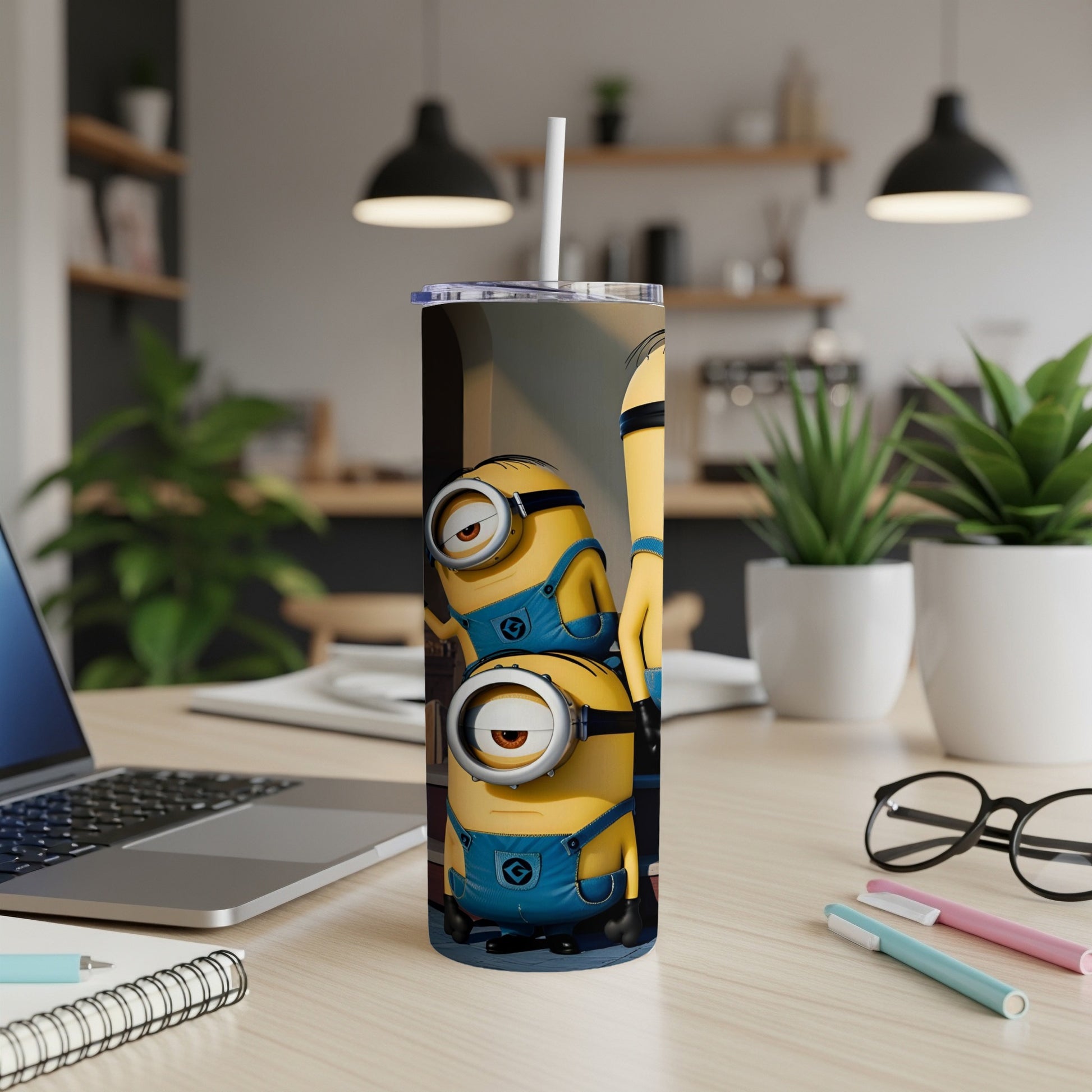 Minions Stuart and Dave on a tall tumbler with straw, on a desk.