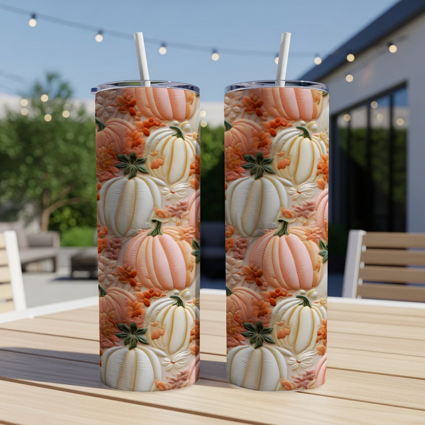 Two tumblers with a textured pumpkin and leaf fall pattern on a table.