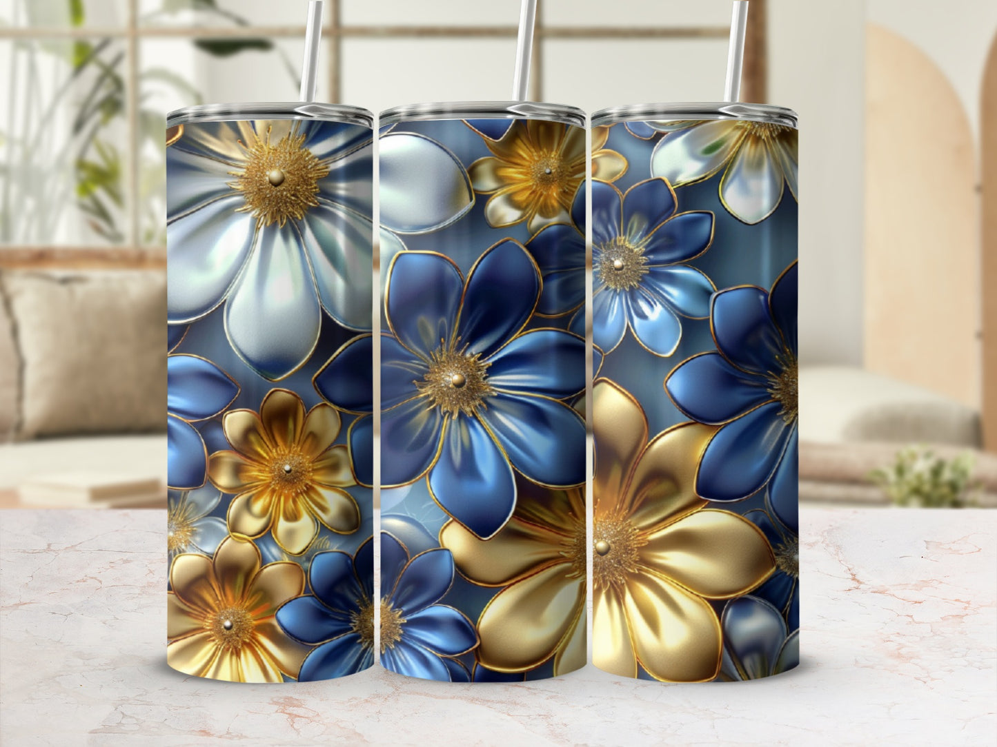 Three floral patterned tumblers with blue and gold flowers.