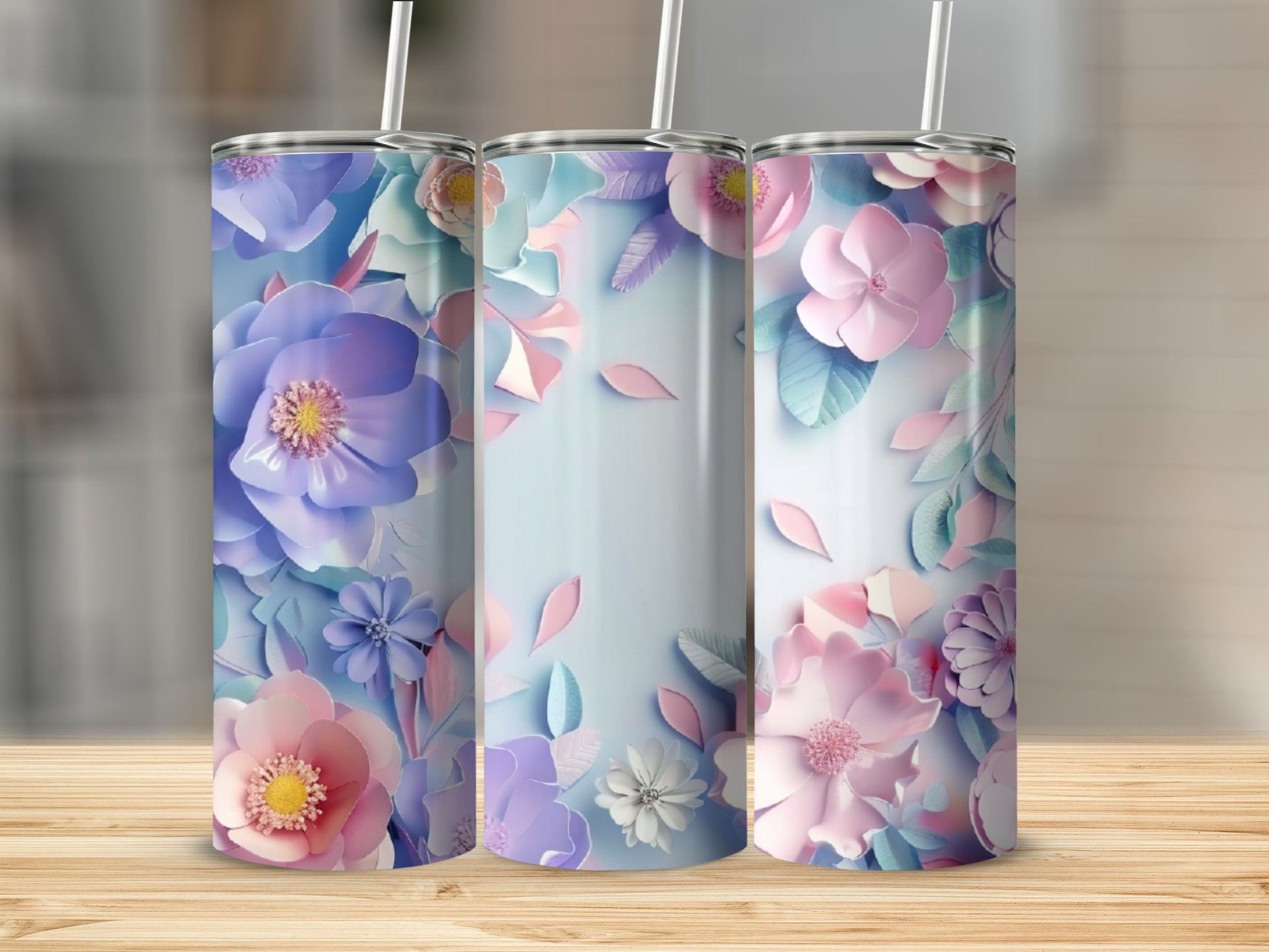 Three tumblers with pastel floral patterns on a wooden surface.