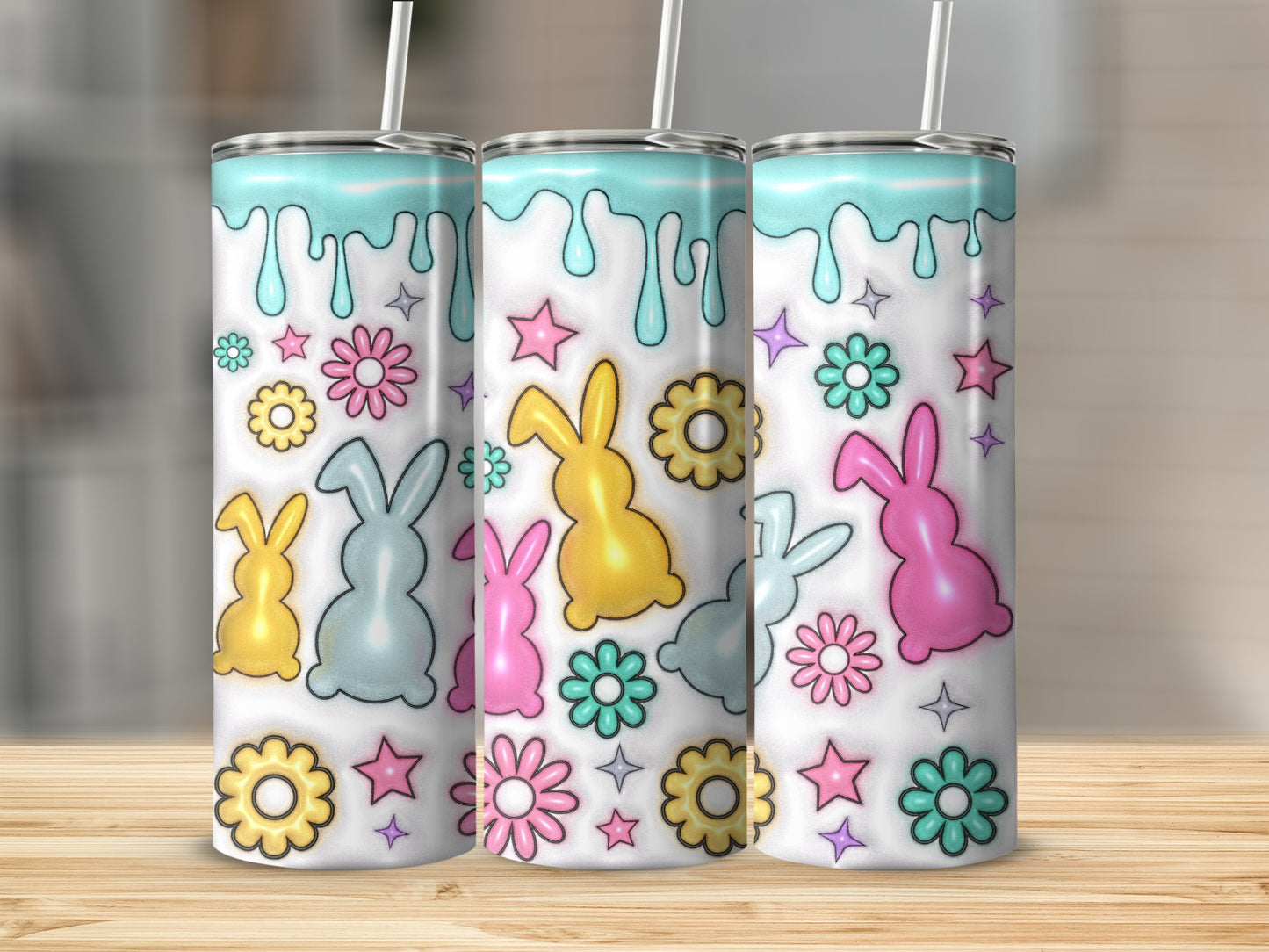 Three colorful tumblers with bunny and flower pattern.