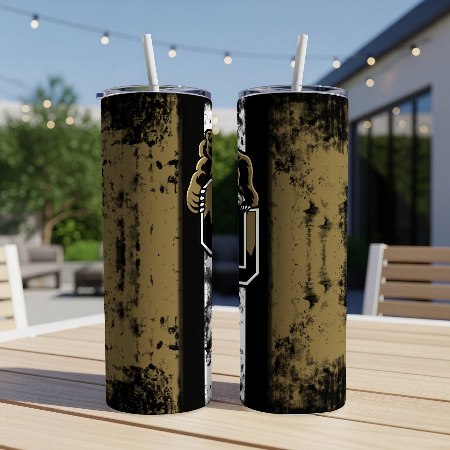Two tumblers with a distressed gold and black design and bear logo, outdoors.
