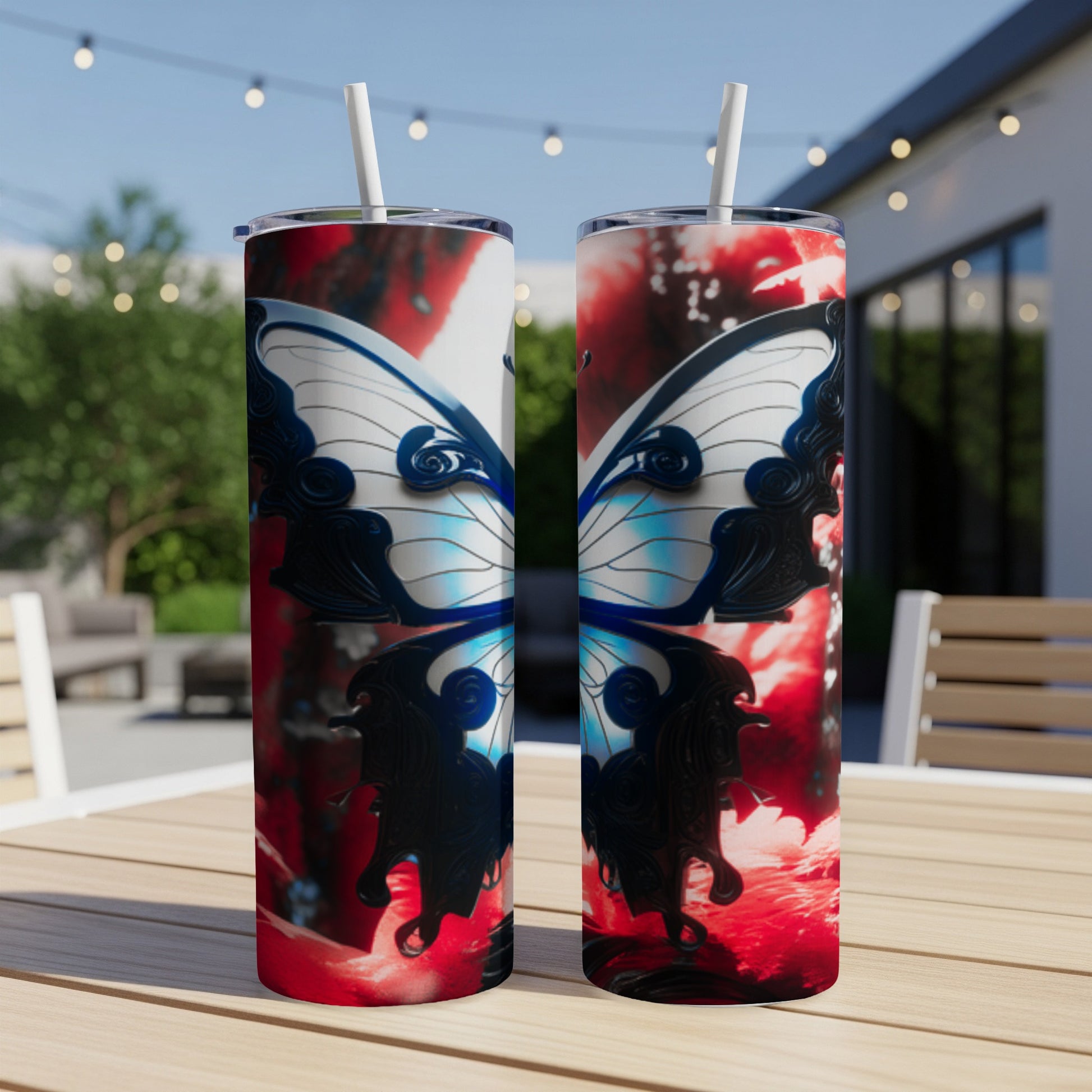 Two tumblers with a blue and white butterfly design on a patio table.