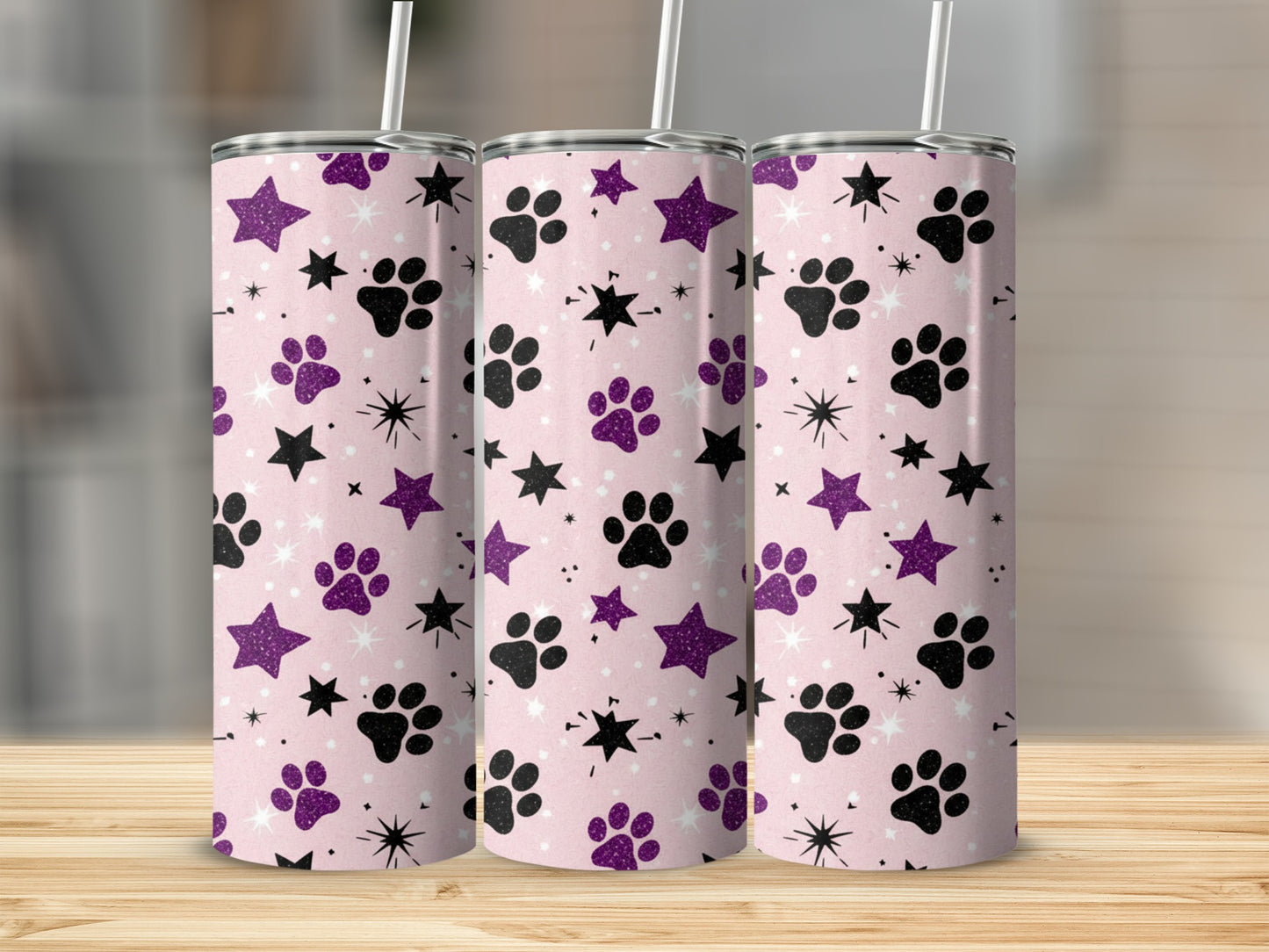 Pink tumbler with black paw prints and purple stars pattern.