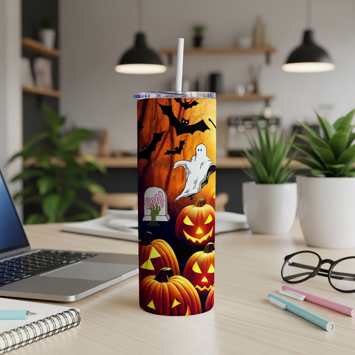Halloween tumbler with pumpkins, bats, ghost, and tombstone graphic.