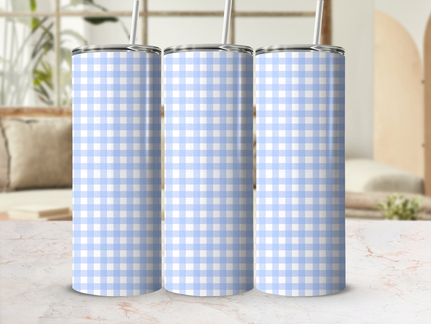 Three light blue and white gingham pattern tumblers with straws.