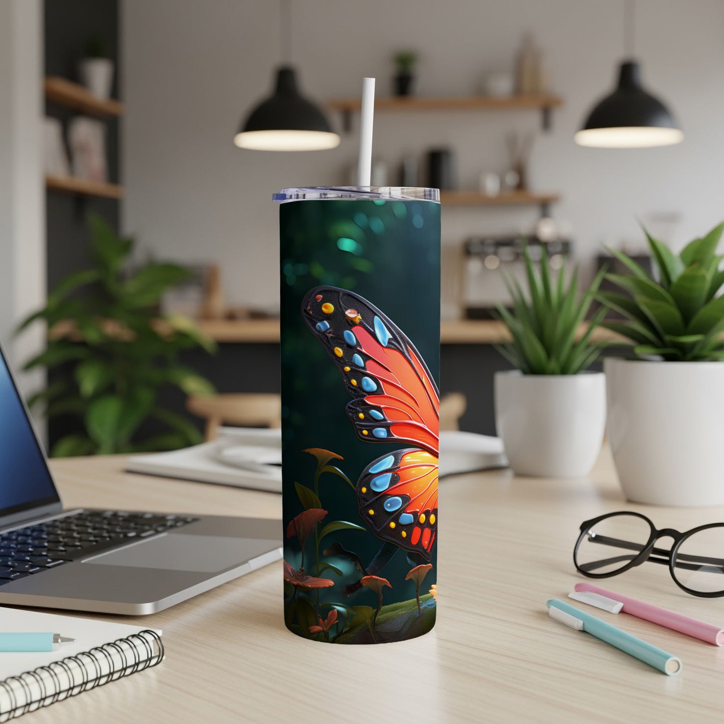 Butterfly wing on a tumbler with plants and office supplies.
