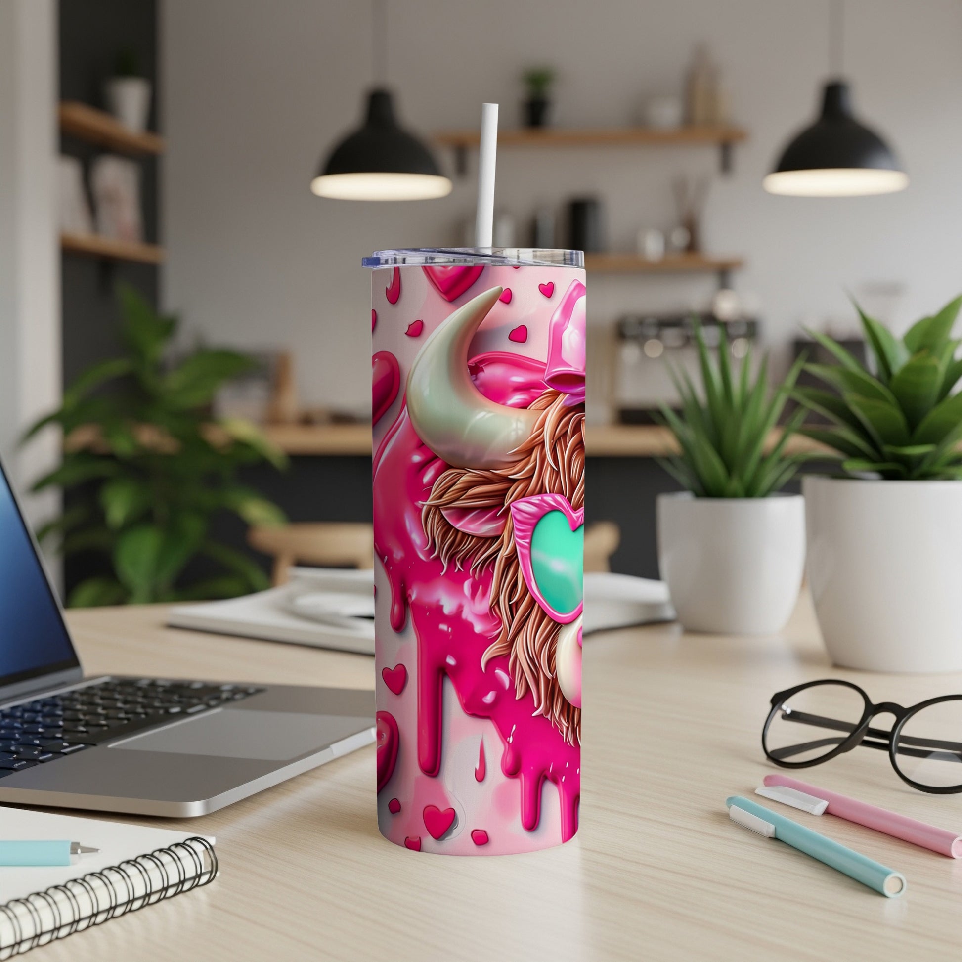 Pink tumbler with cow wearing heart sunglasses, on a desk.