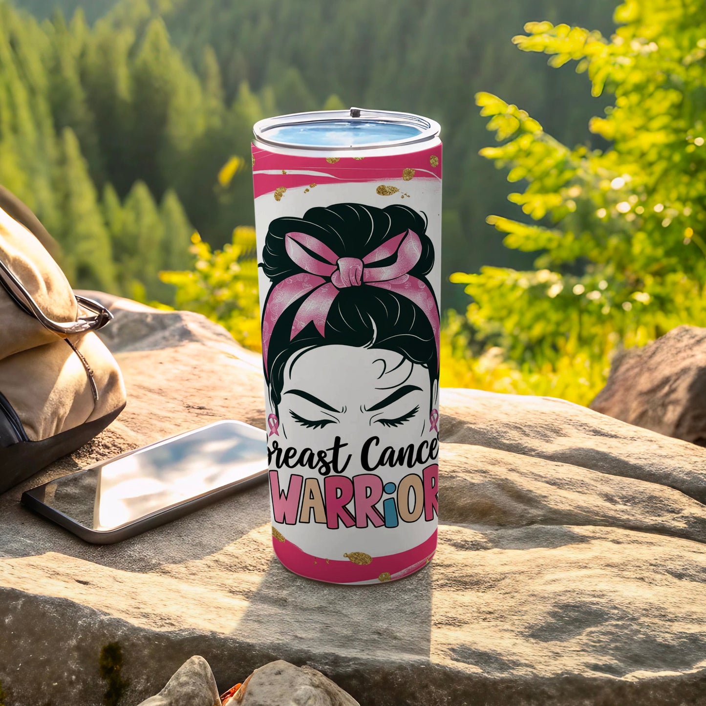 Pink ribbon tumbler with "Breast Cancer Warrior" text on a rock.