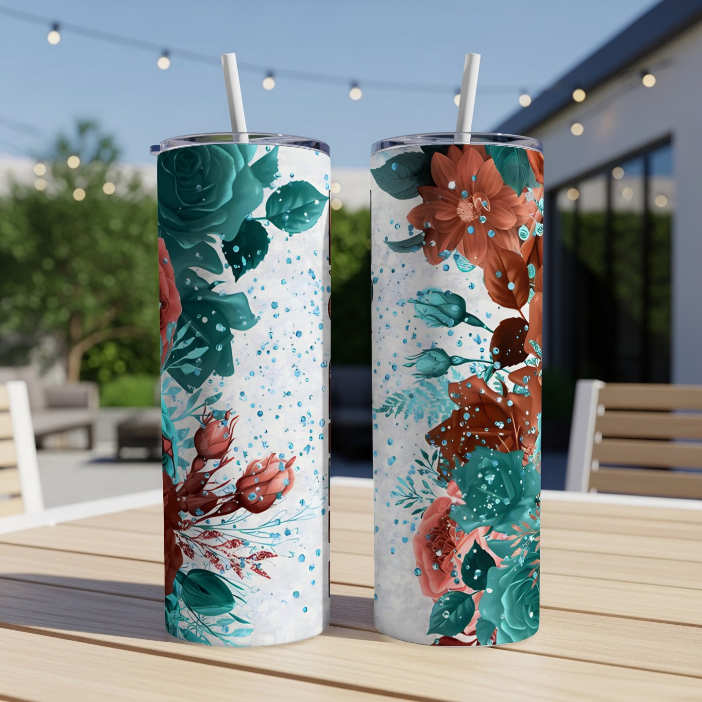 Two white tumblers with teal and rust floral design and speckles.