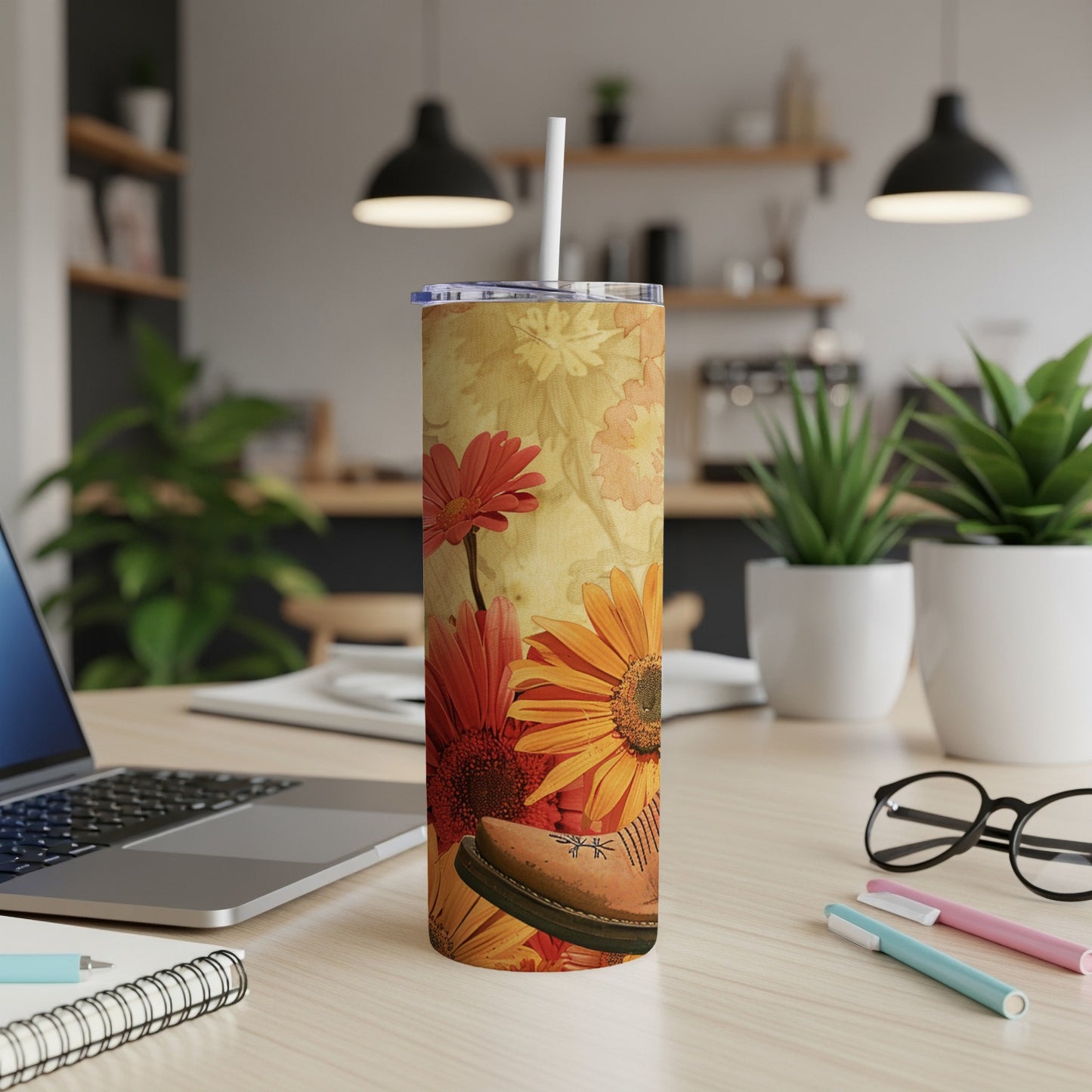 Floral tumbler with a shoe design on a wooden desk.