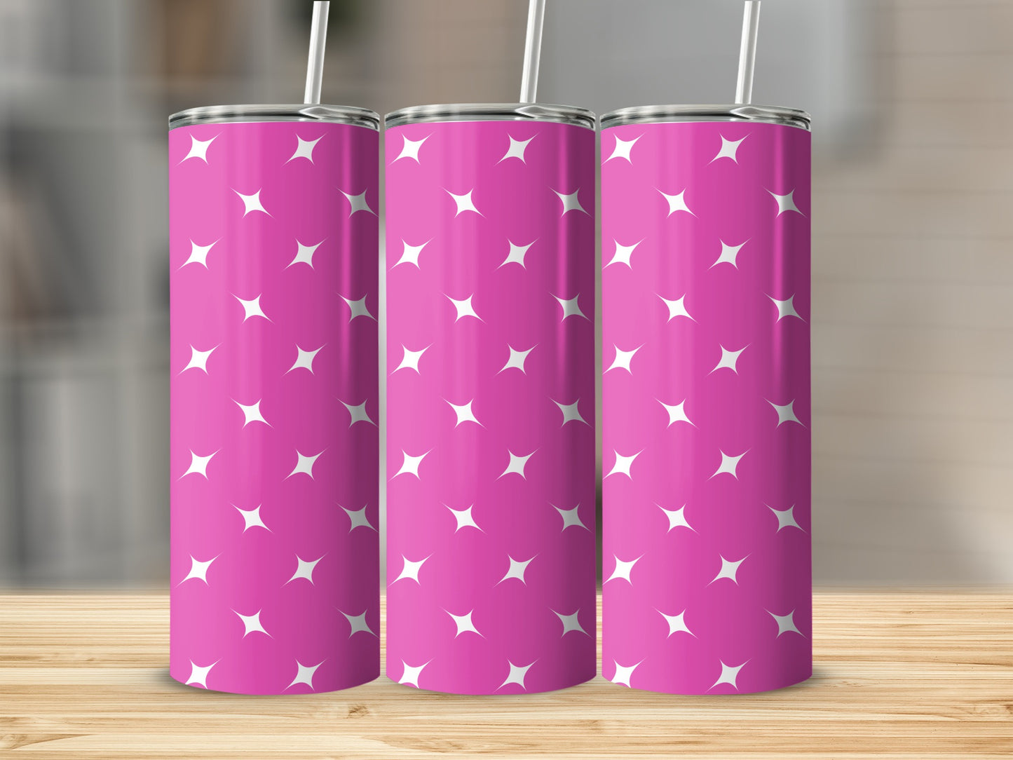 Pink tumbler with a white star pattern and a straw.