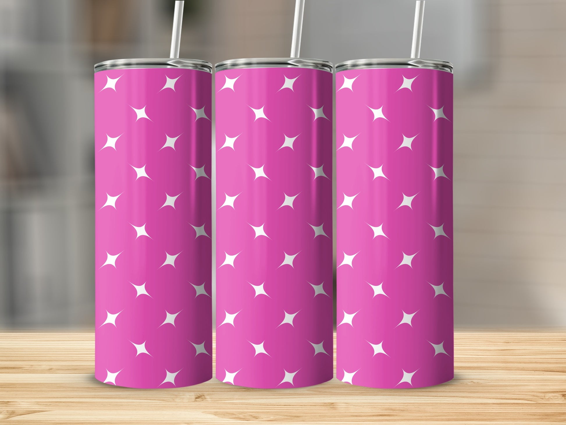 Pink tumbler with a white star pattern and a straw.