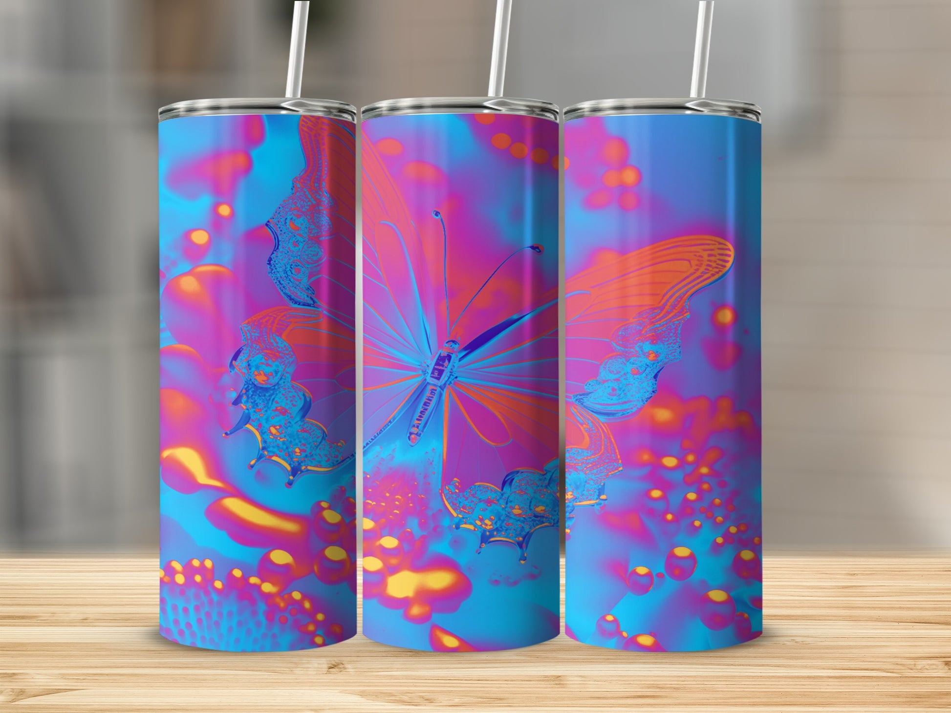 Three tumblers with vibrant, abstract butterfly and bokeh designs.