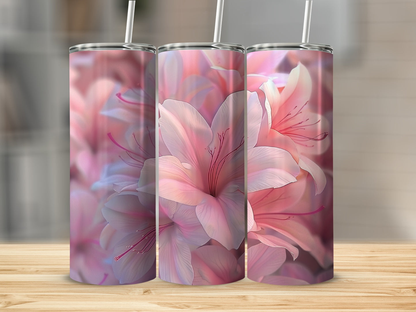 Three tumblers featuring a close-up floral print of soft pink and white blossoms.