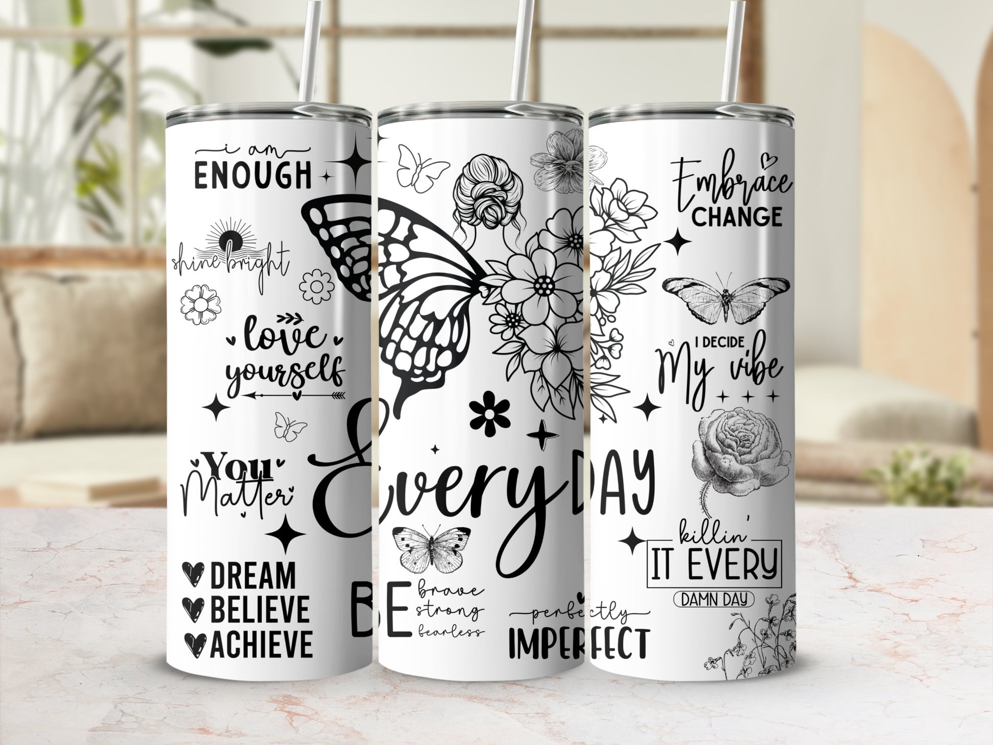 Three tumblers with inspirational quotes and floral butterfly designs.