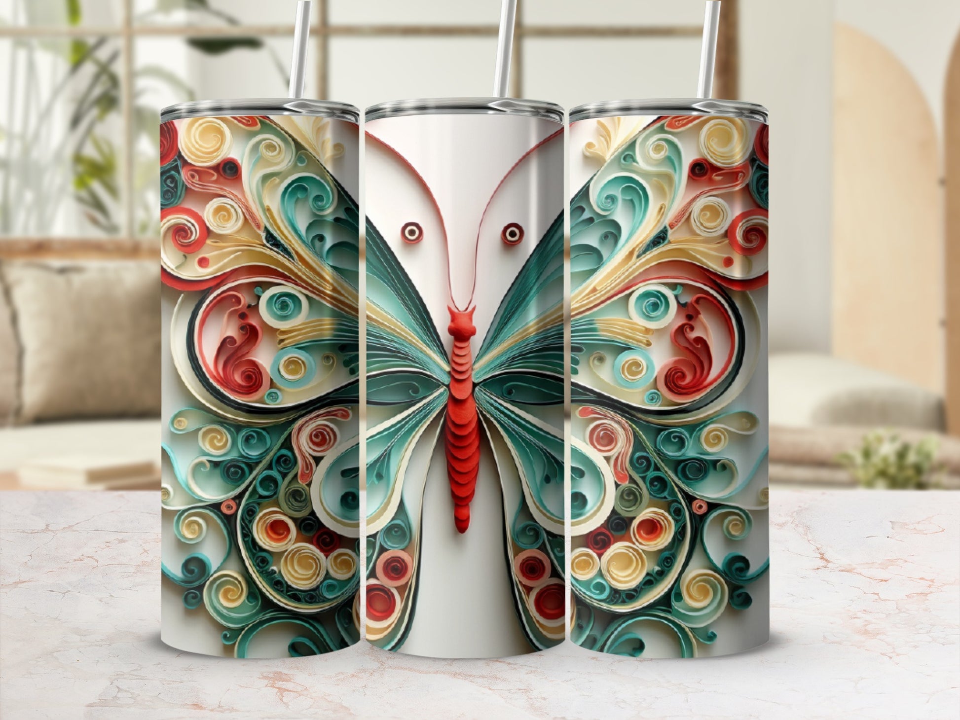 Three tumblers with ornate butterfly wing designs in various colors.