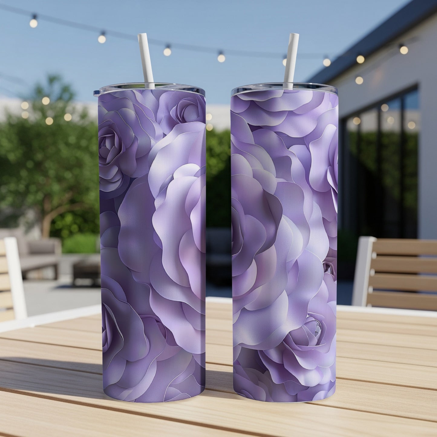 Two tall purple floral tumblers with straws on a wooden table.