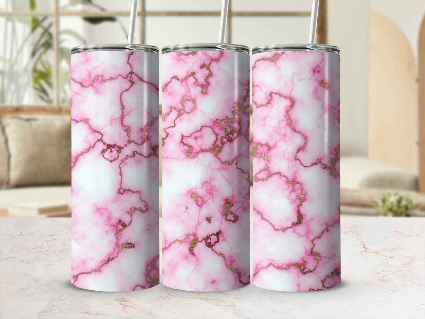 Three tumblers with a pink and gold marble pattern.