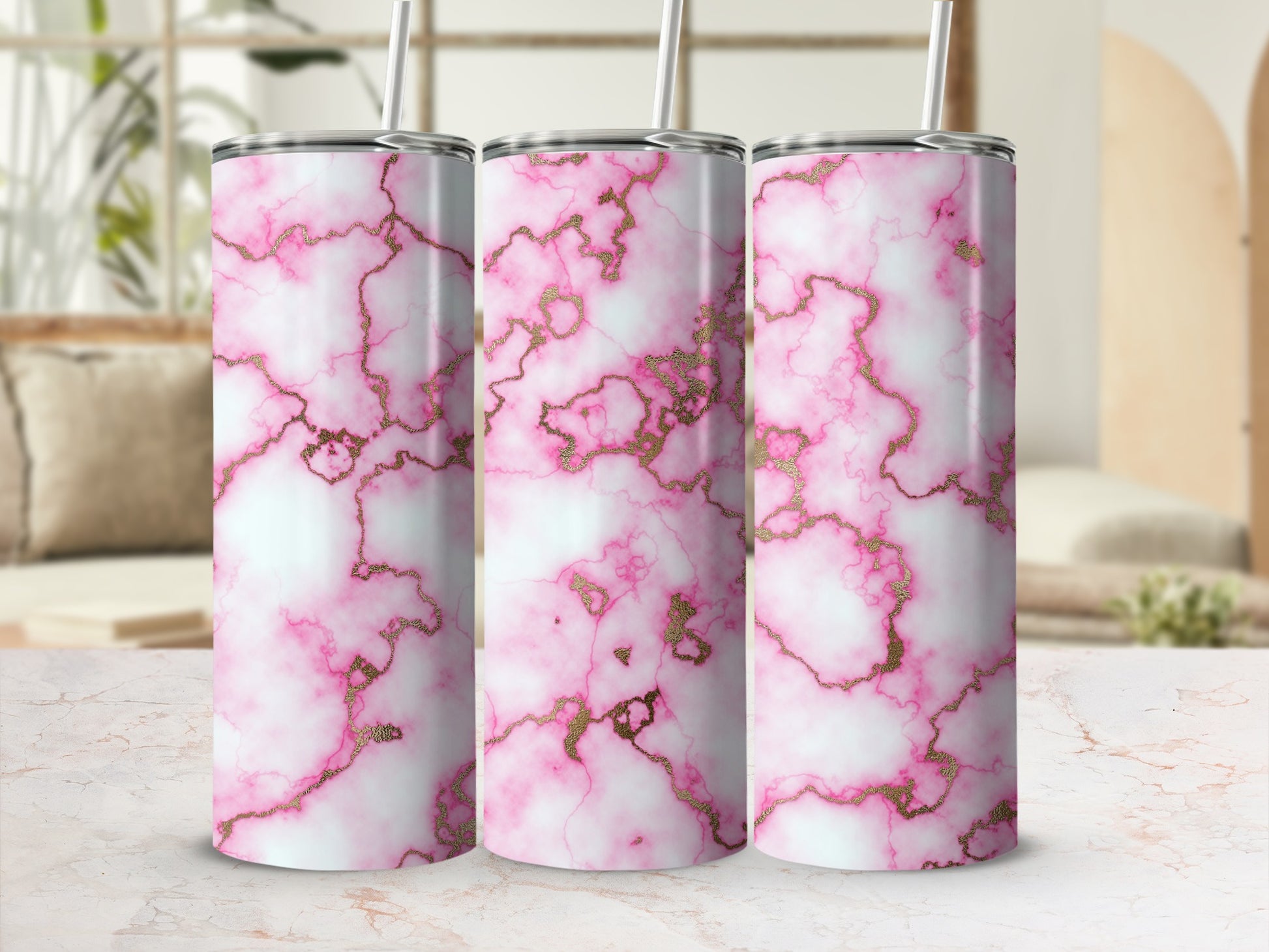 Three tumblers with a pink and gold marble pattern.