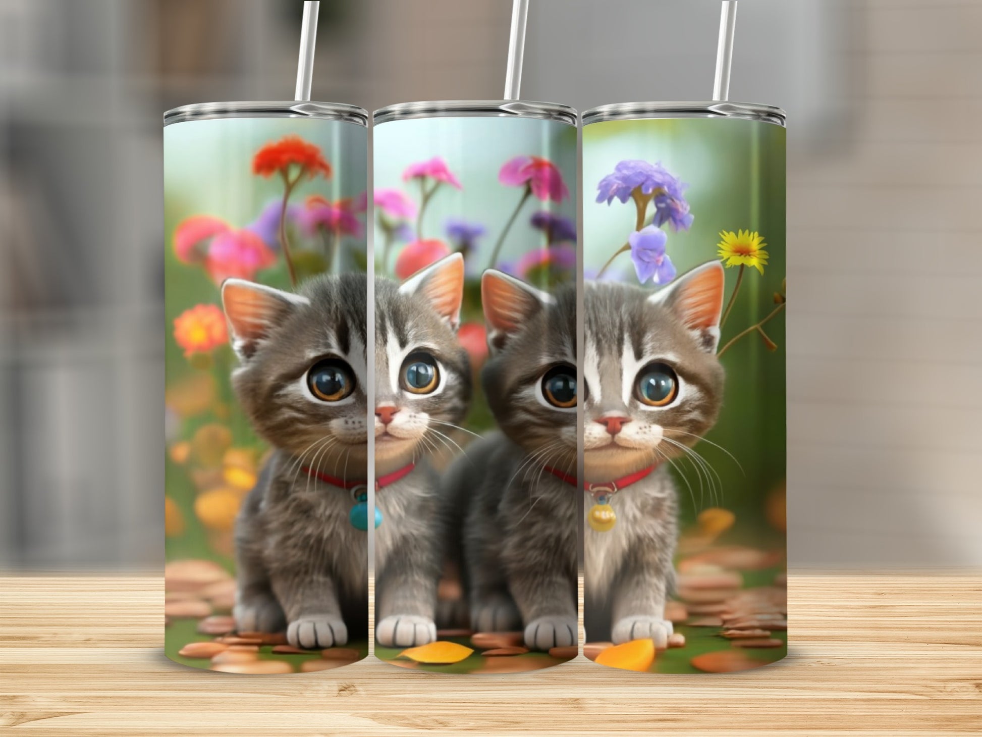 Three cartoon kittens in front of a floral background on tumblers.
