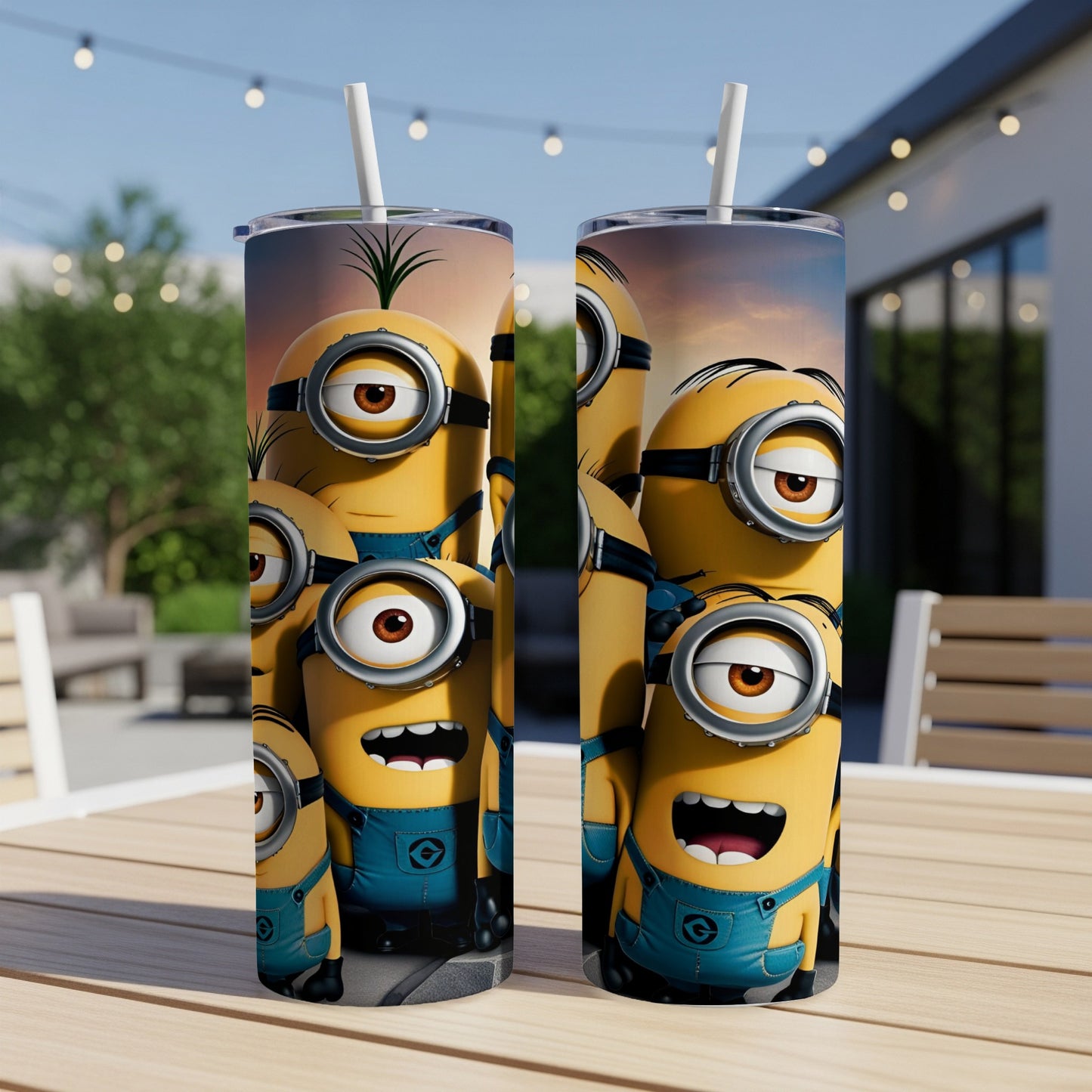 Two Minions tumblers with a straw on a table, outdoor patio setting.