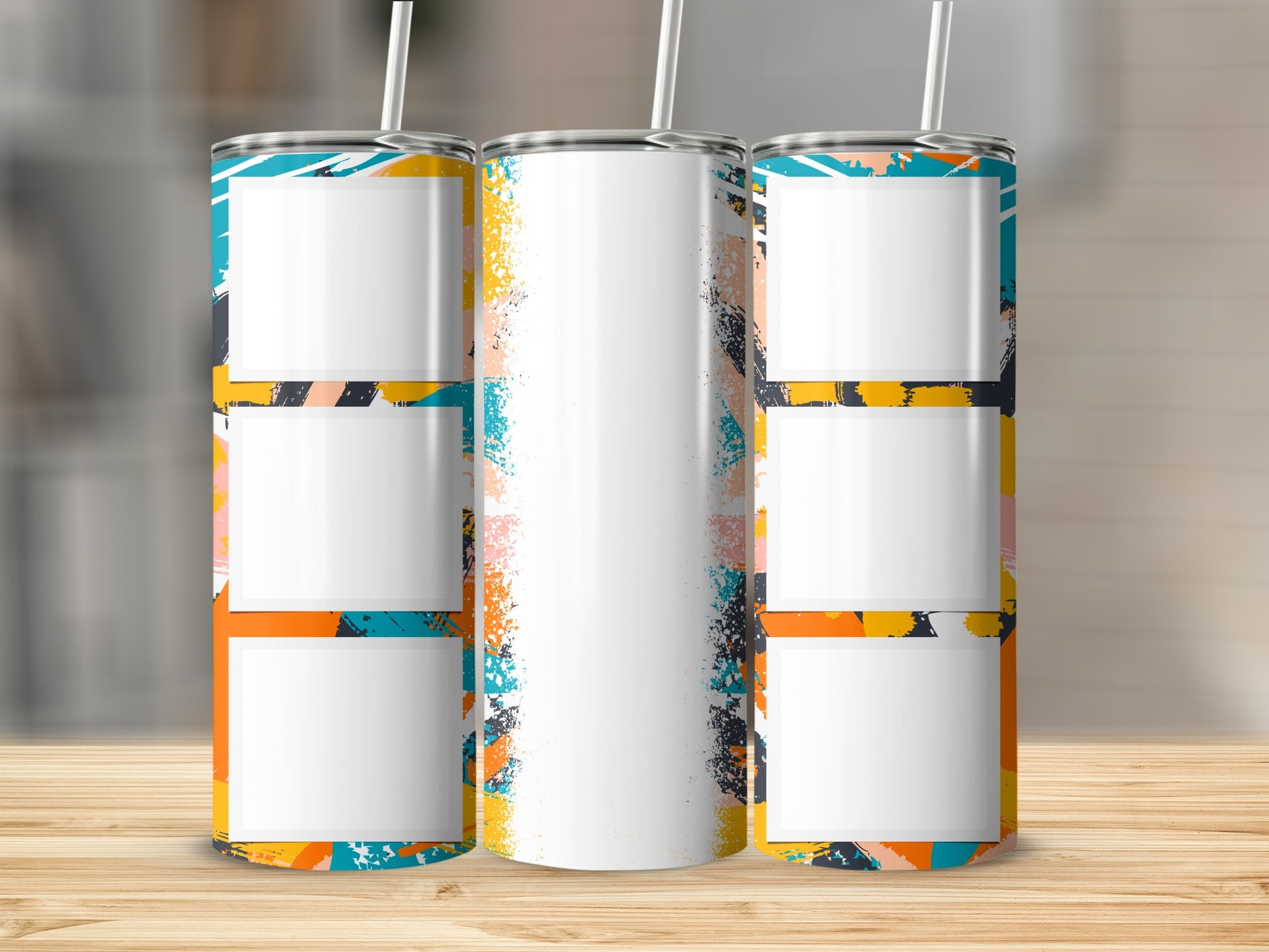 Three blank tumblers with abstract colorful paint splatters.