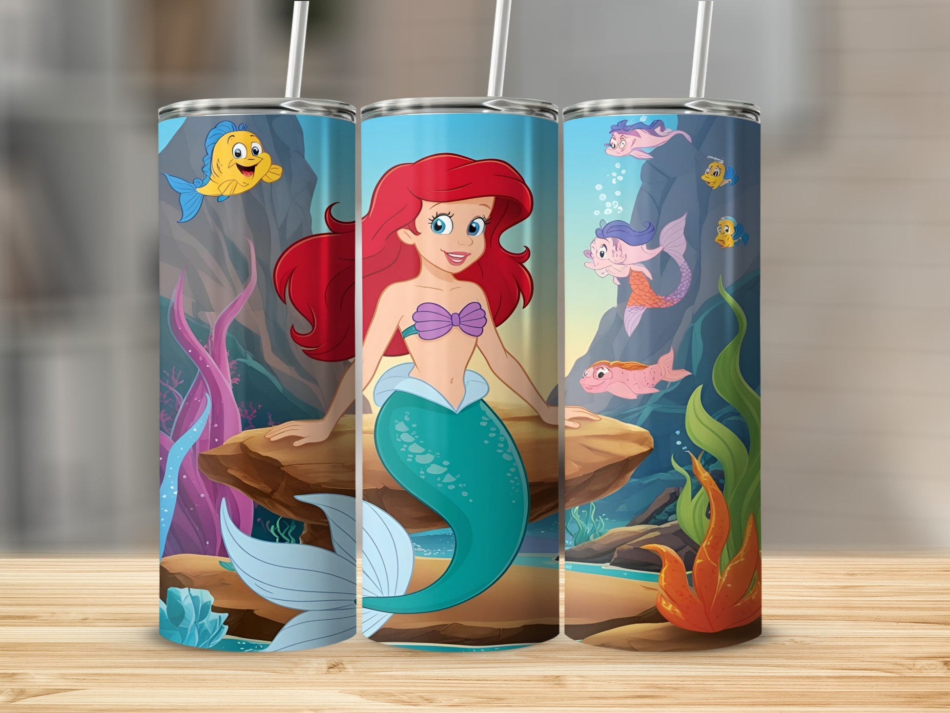 Ariel from The Little Mermaid smiling on a rock with fish and coral.