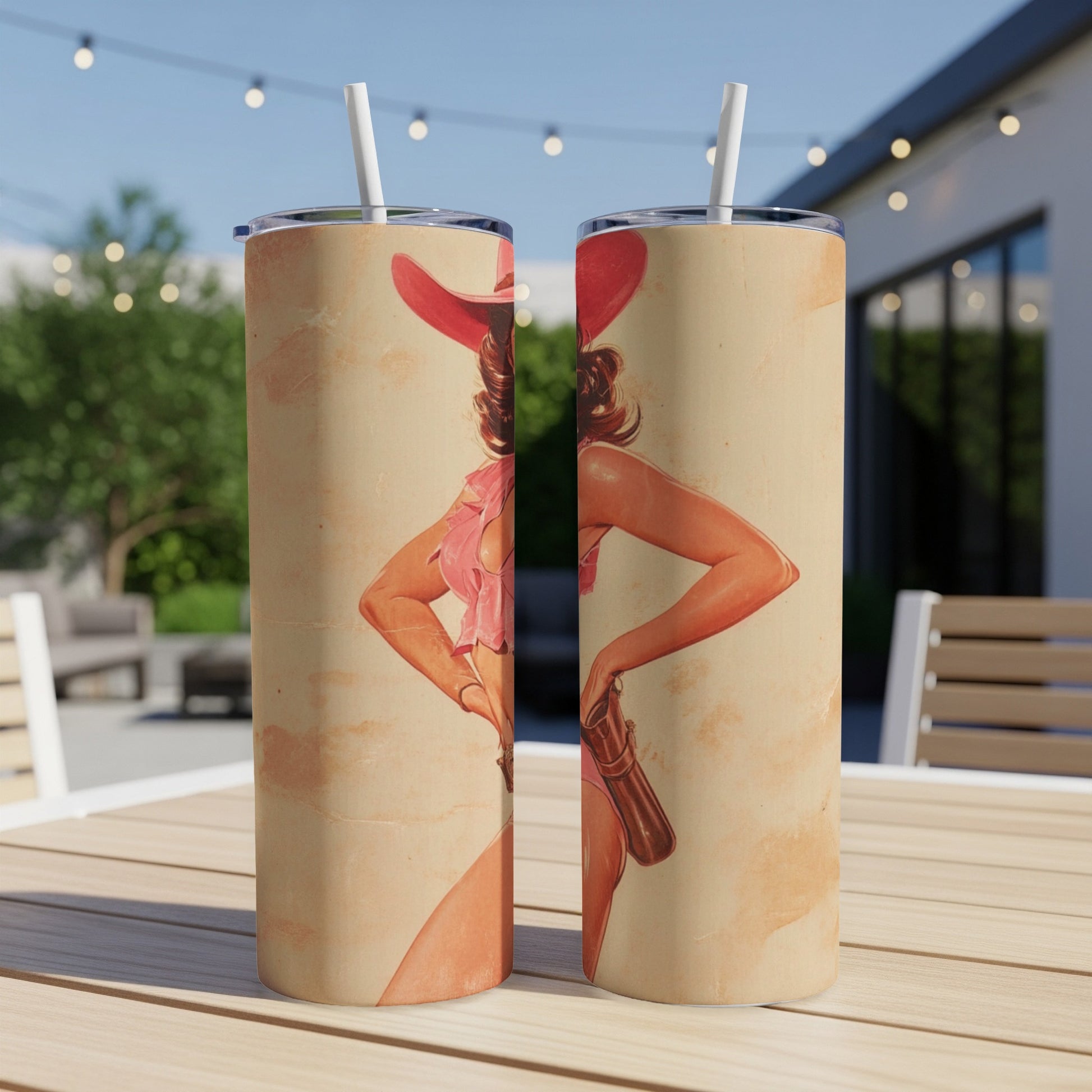 Cowgirl pin-up illustration on two light-colored tumblers with straws.