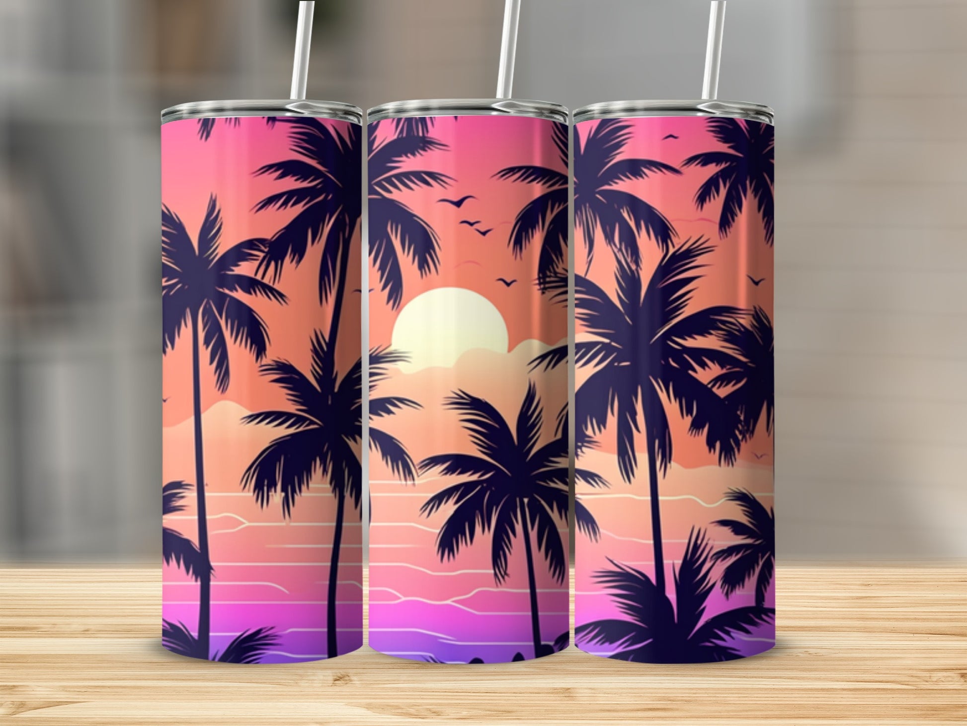 Three tumblers with a tropical sunset and palm tree silhouette design.