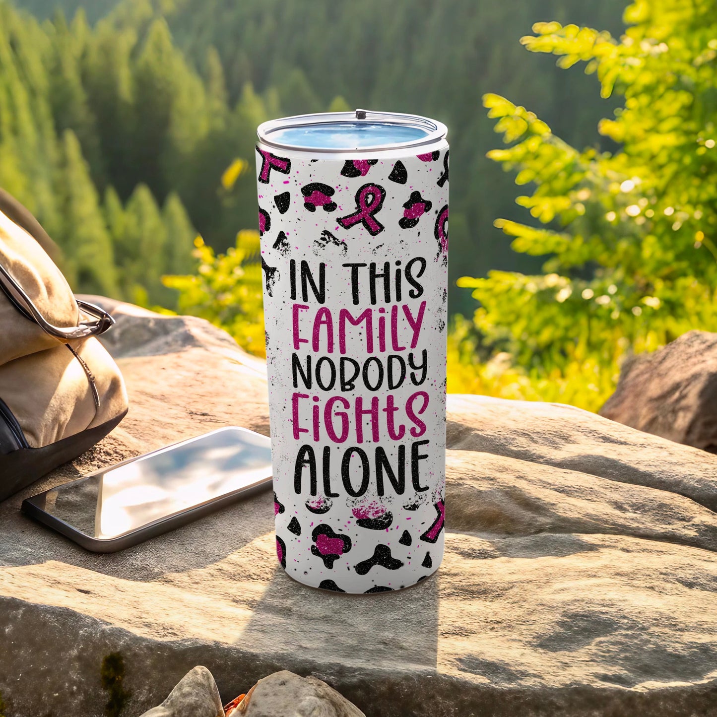 Tumbler with text "In This Family Nobody Fights Alone" on leopard print.