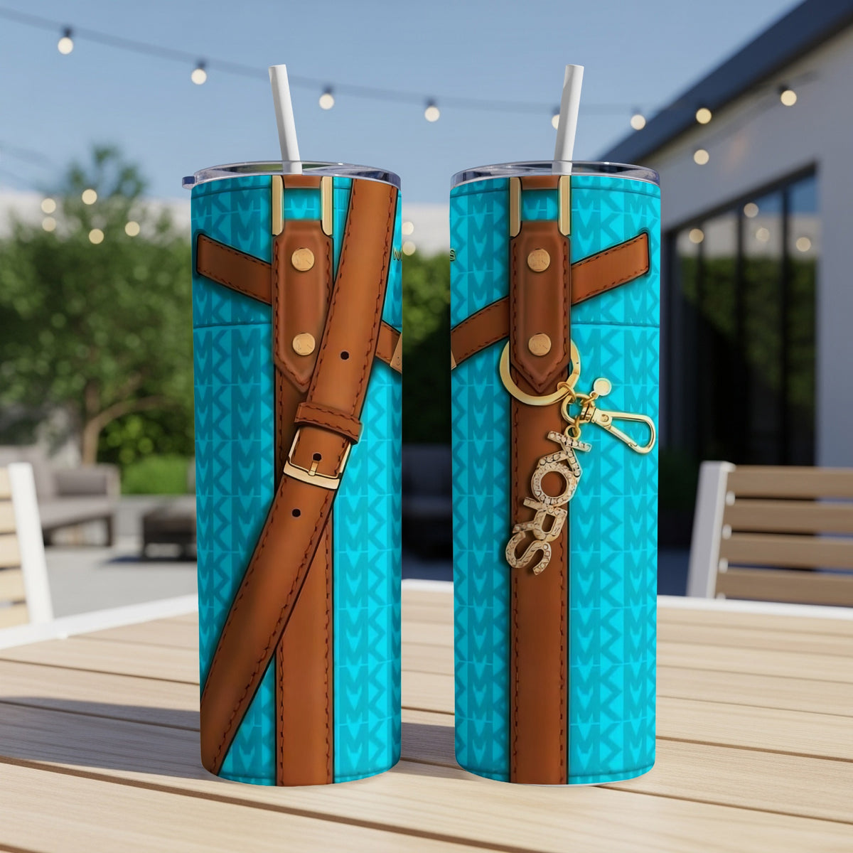 Two turquoise tumblers with brown strap accents and MK pattern, one with a "love" charm.