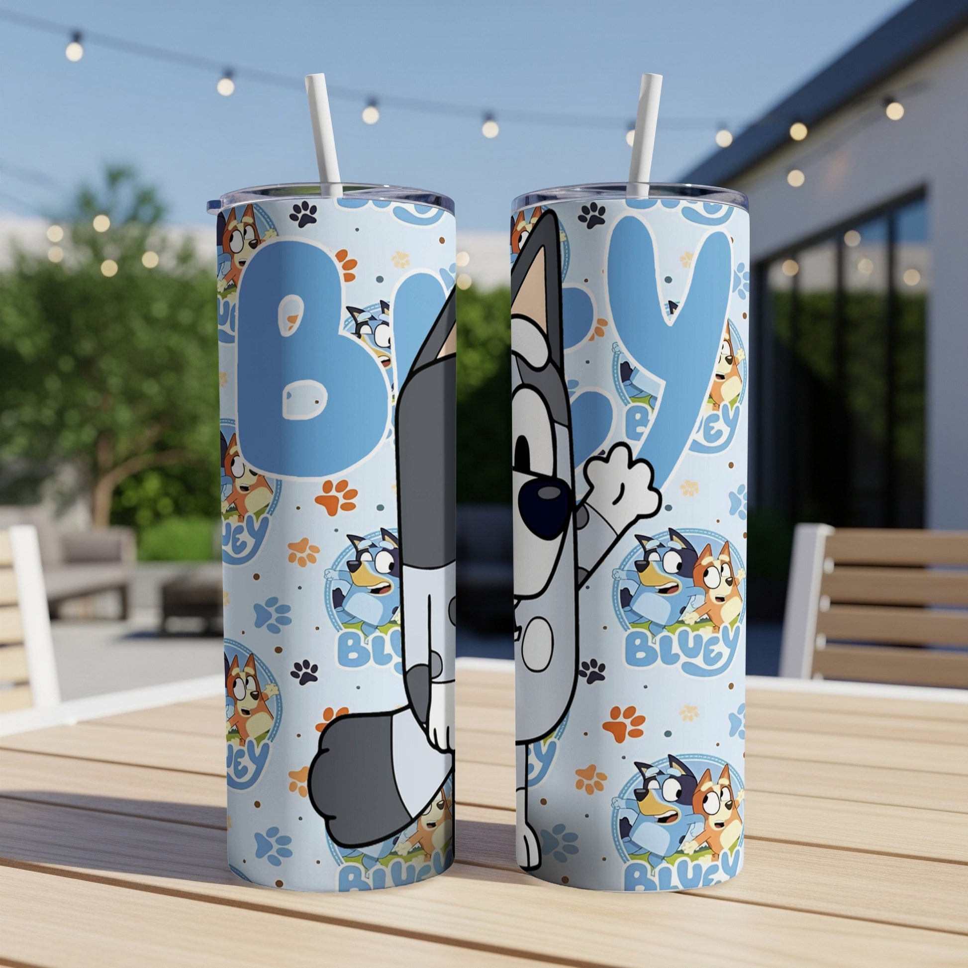 Bluey and Bingo characters on a blue tumbler with paw print pattern.