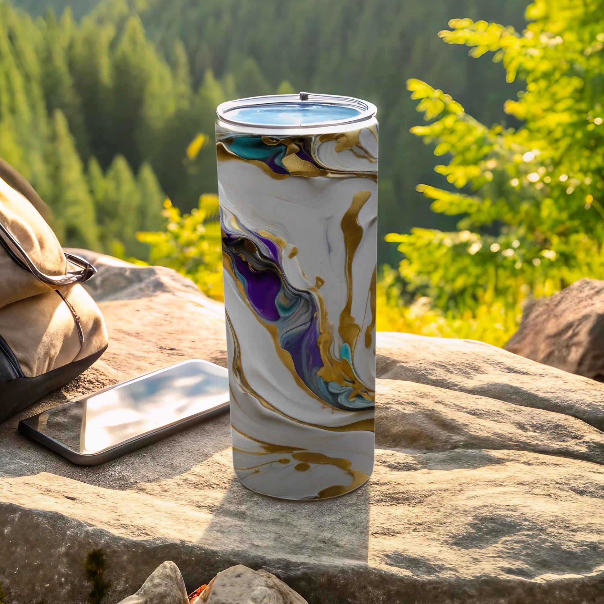 White and gold marbled tumbler with purple accents on rocky terrain.
