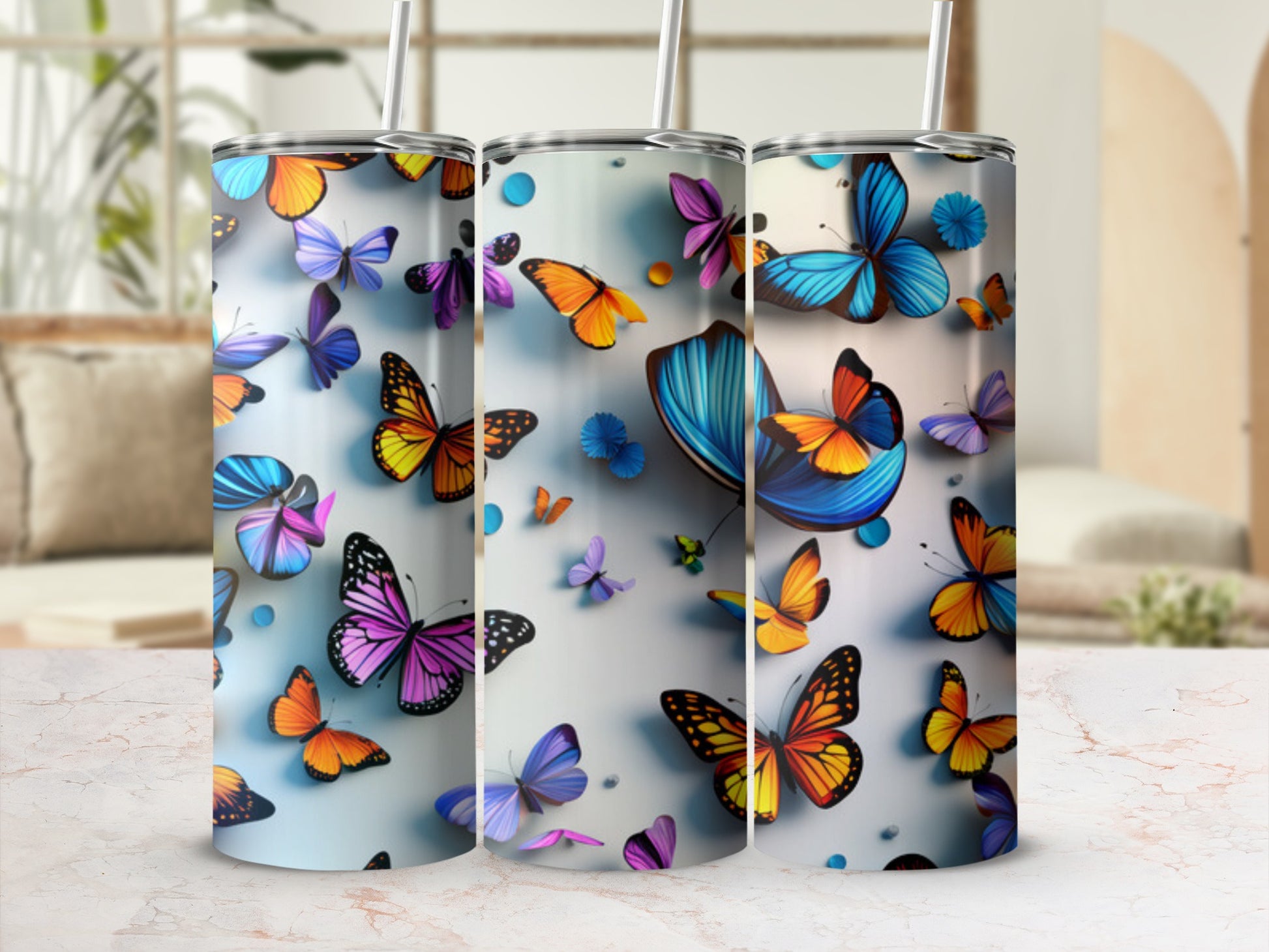 Three tumblers decorated with colorful, realistic butterflies and floral accents.