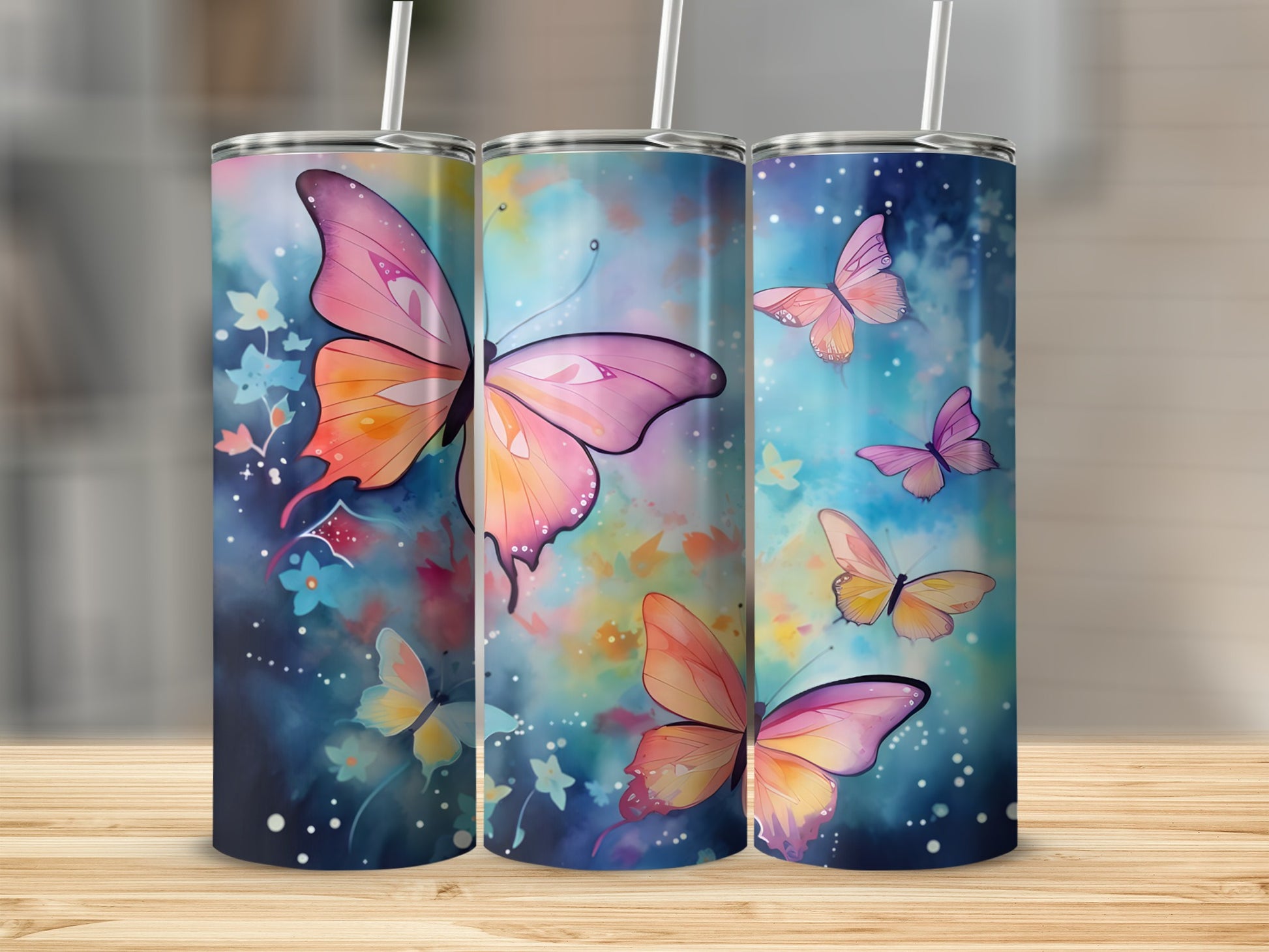 Three tumblers with watercolor butterflies and floral designs.